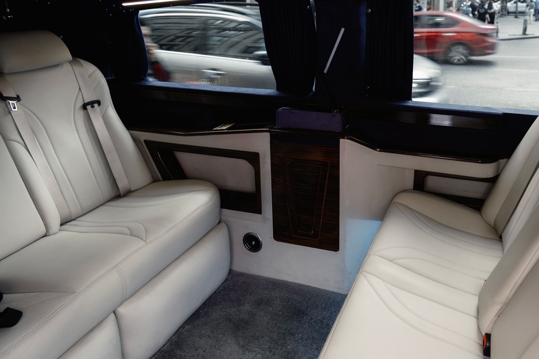 Interior of a luxury vehicle with cream leather seats, ideal for airport pickups.