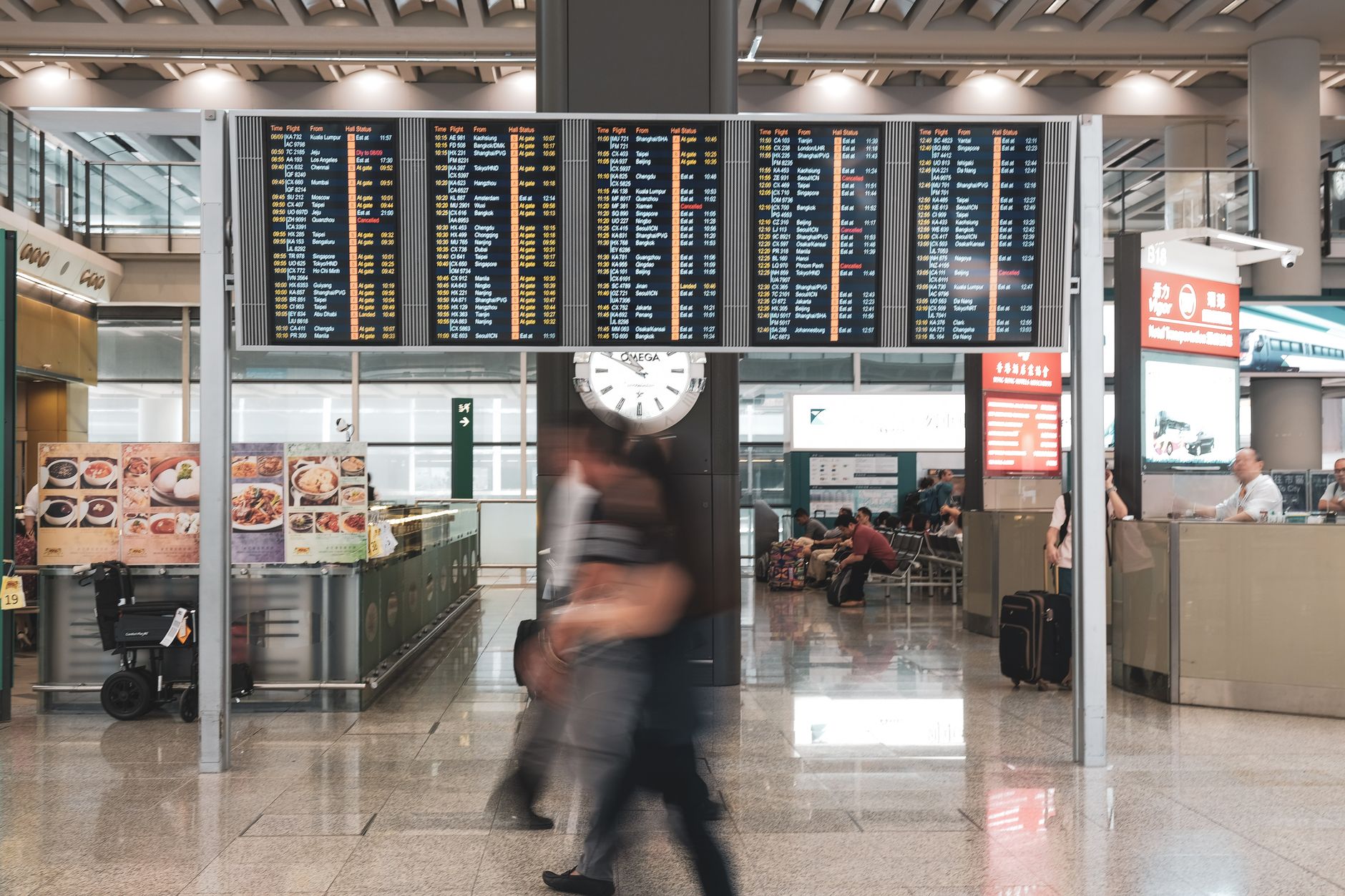 Overview of flight information board showing departures at an airport.