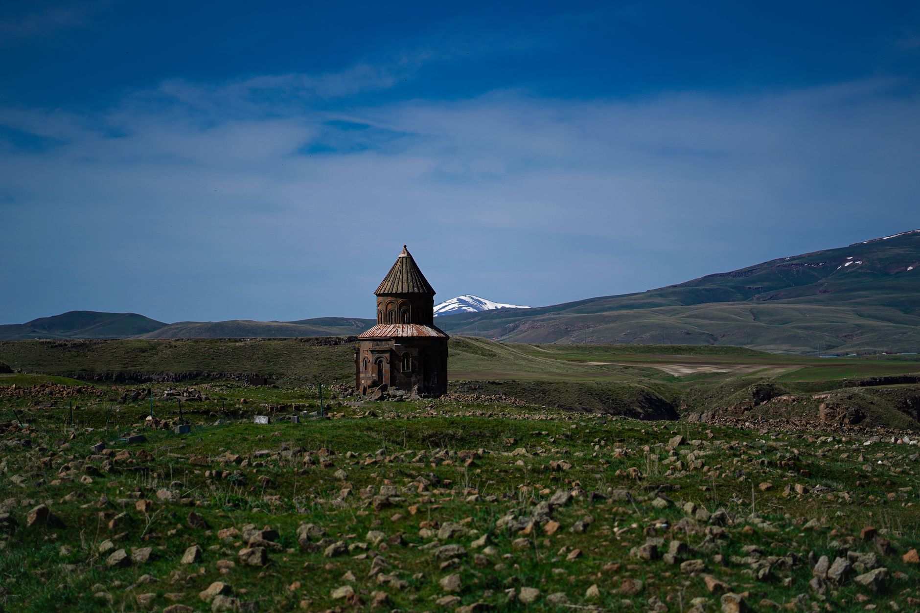 View of the Church of St. Gregory of Tigran Honents surrounded by hills and mountains in Armenia.