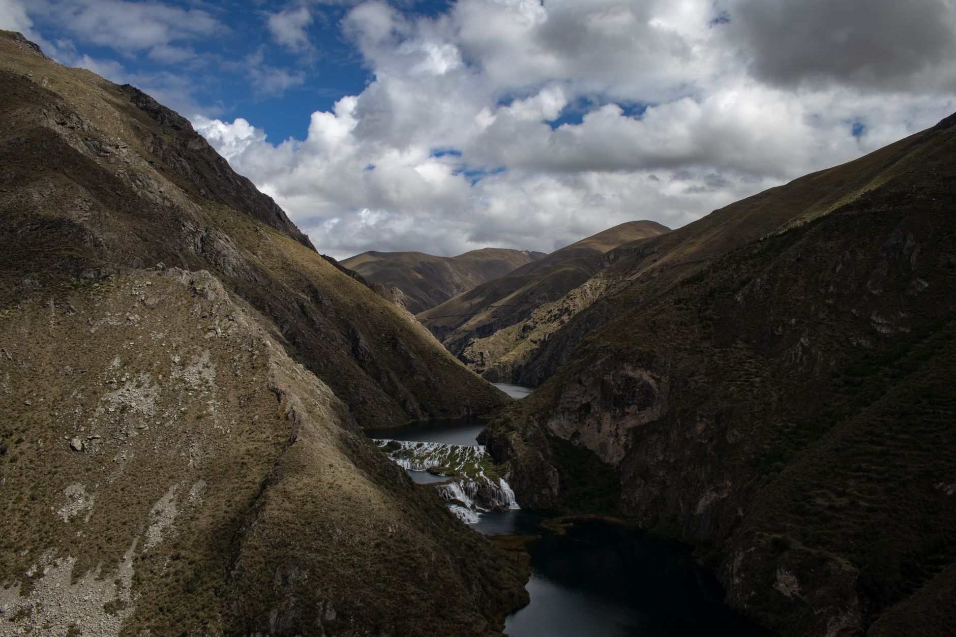 Panoramic view of the Arpaçay River gorge, showcasing hills and cloudy skies.