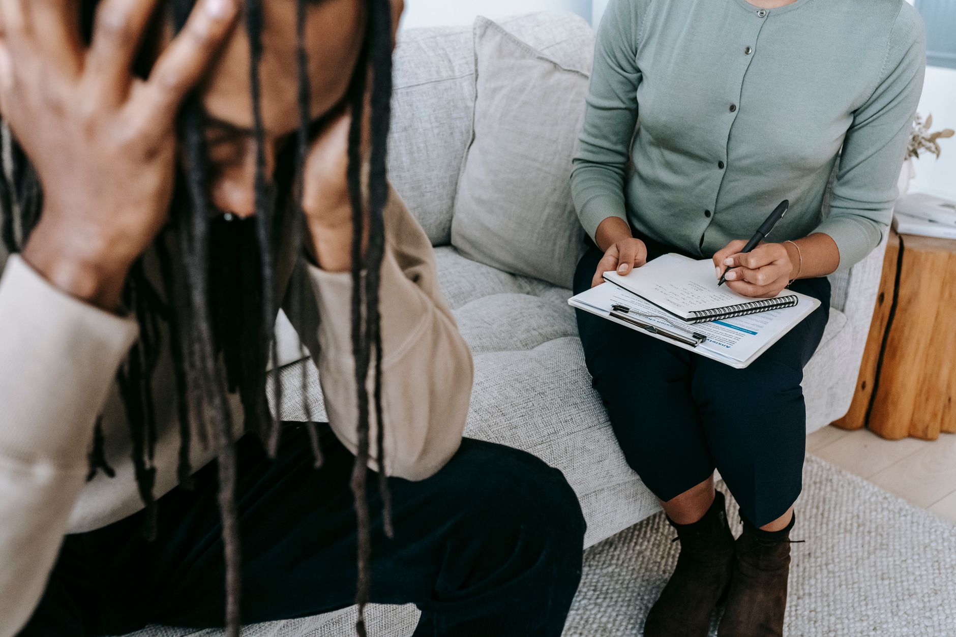 A psychologist listens compassionately to a patient during a session, focusing on mental health care.