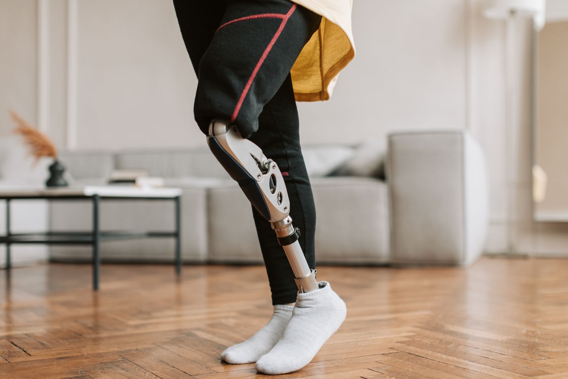 Close-up of a custom-made prosthetic leg in a modern living room.