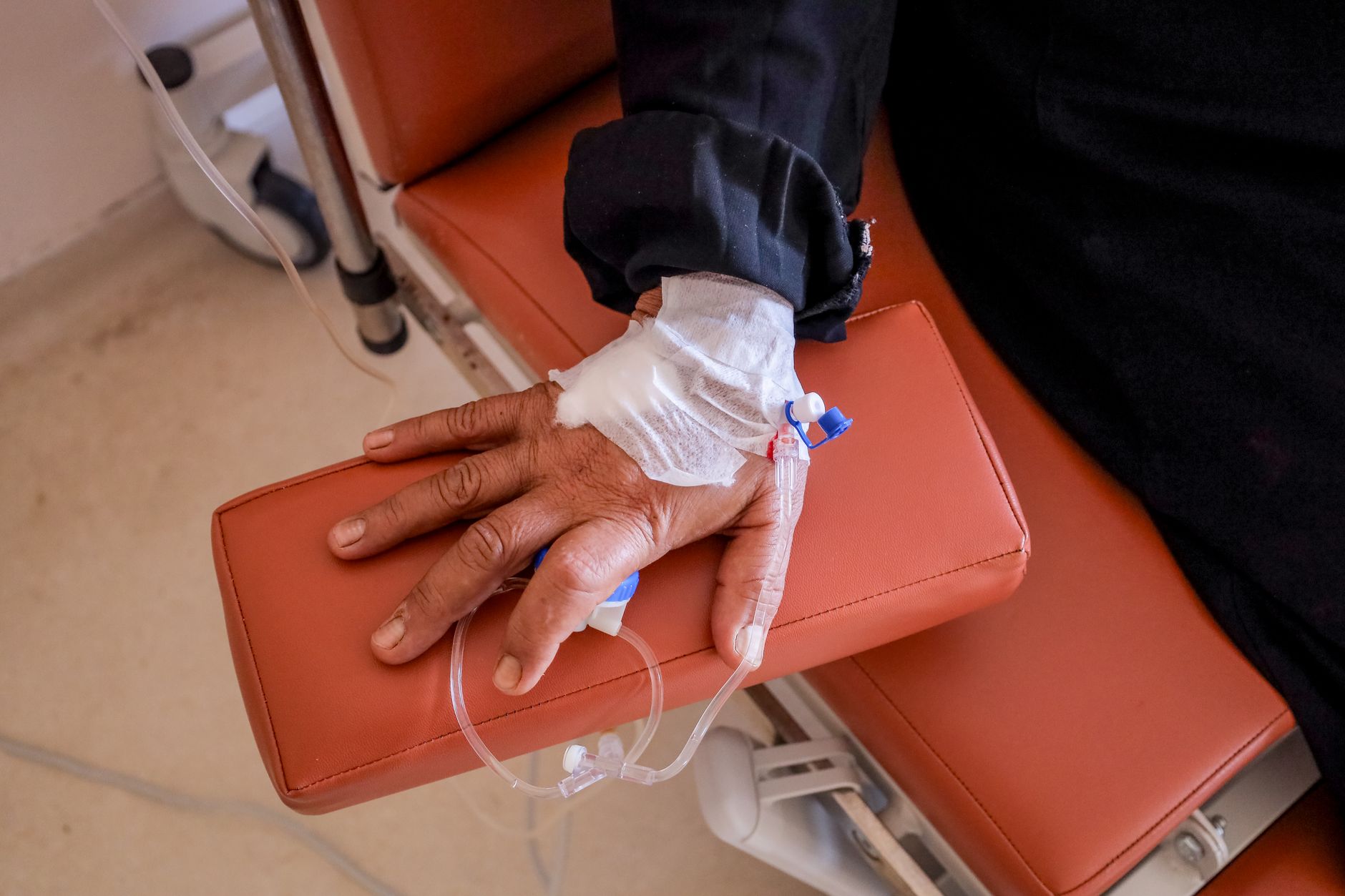 Patient's hand with IV access, illustrating medical treatment for prostate cancer.