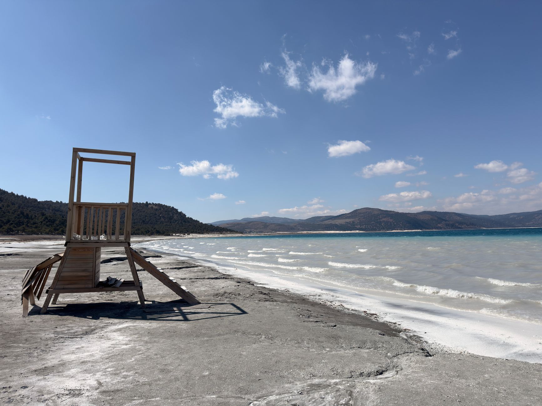 Lifeguard stand on the shores of Salda Lake with clear turquoise waters and white sand beach.