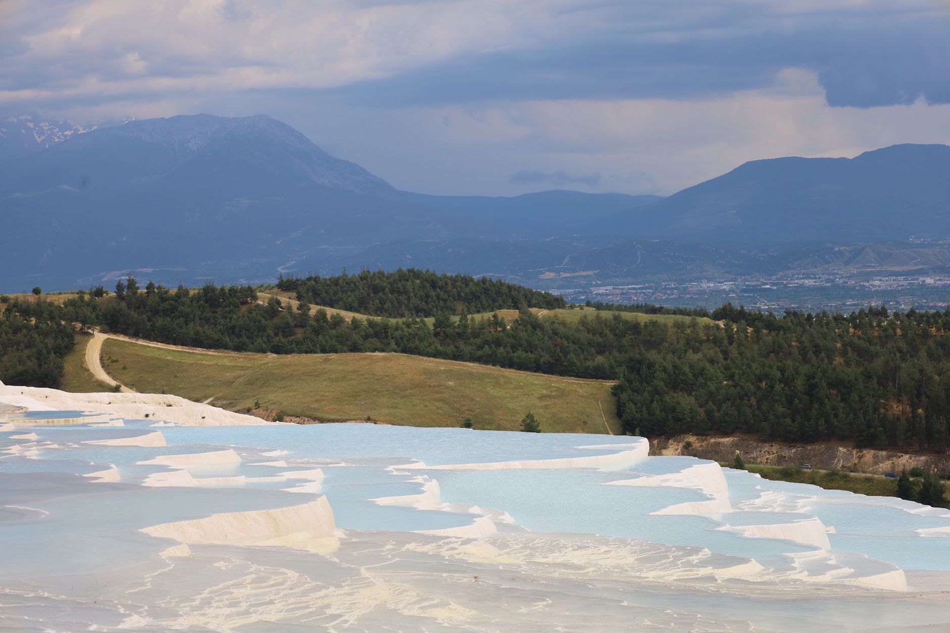 Beautiful terraces of thermal pools in Bursa's Çekirge district, surrounded by lush greenery and mountains.