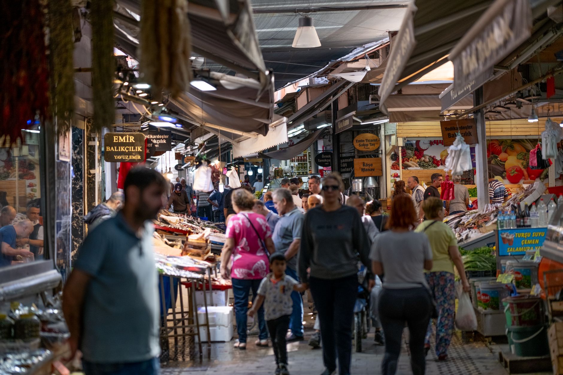 Busy market street in Kayseri, showcasing stalls of fresh produce and local goods.