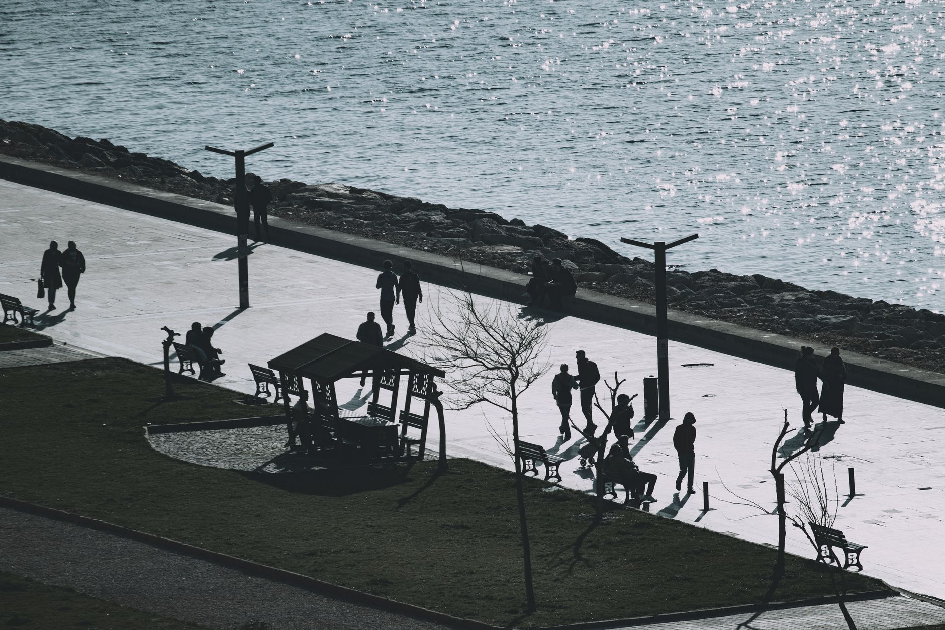 People enjoying a serene waterfront walkway, ideal for post-operative walks and family time.