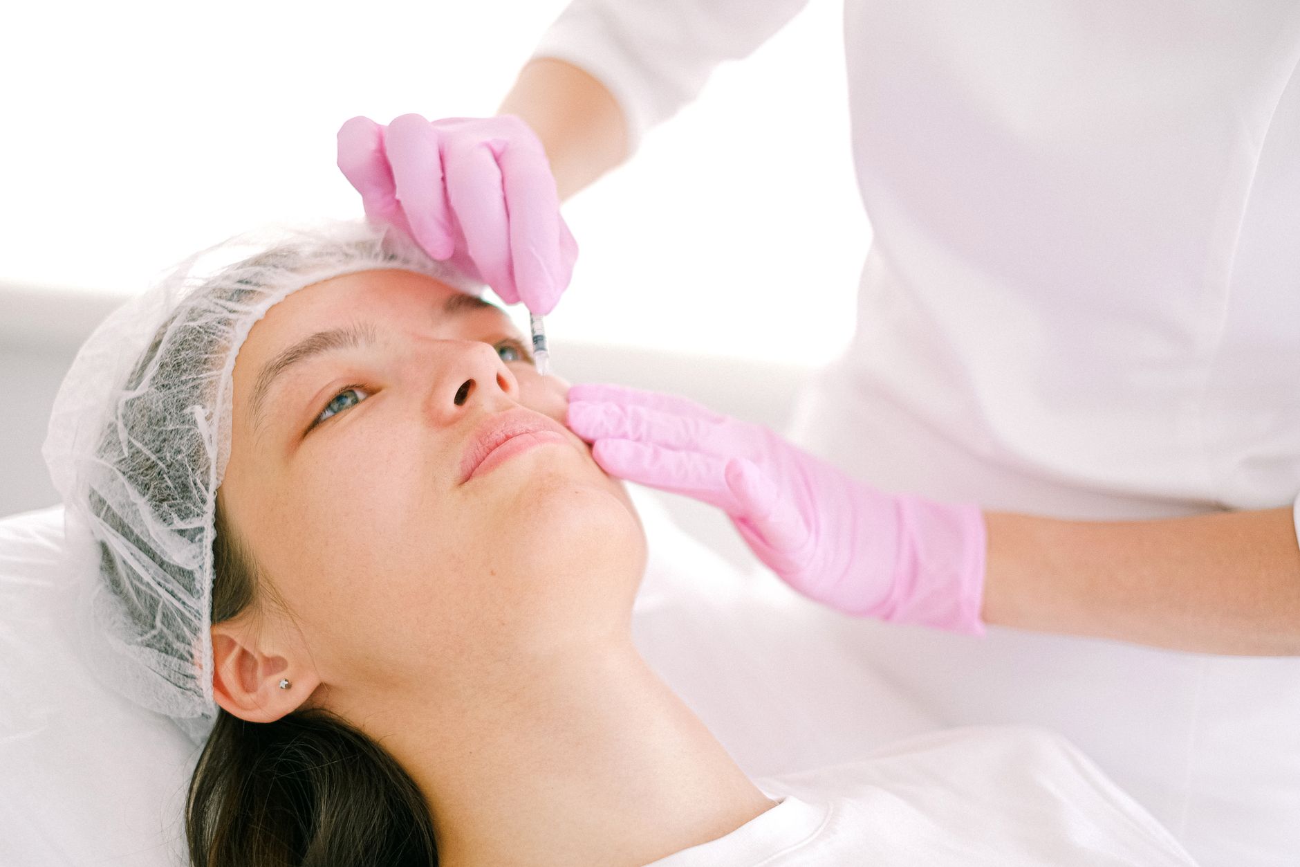 A healthcare professional administering botulinum toxin injections to a patient for migraine relief.