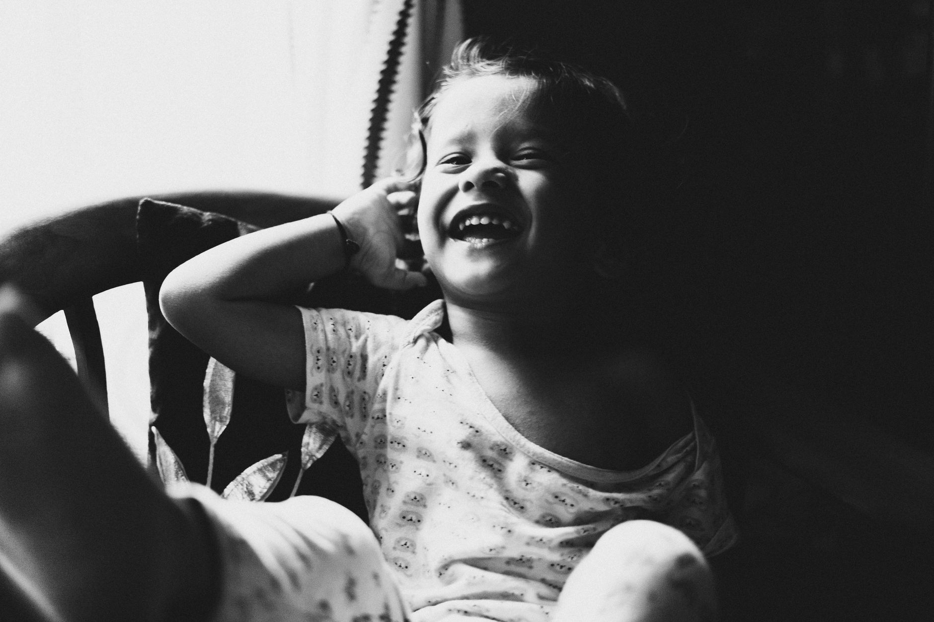 A smiling child with a healed cleft lip enjoying playtime in an Istanbul park.