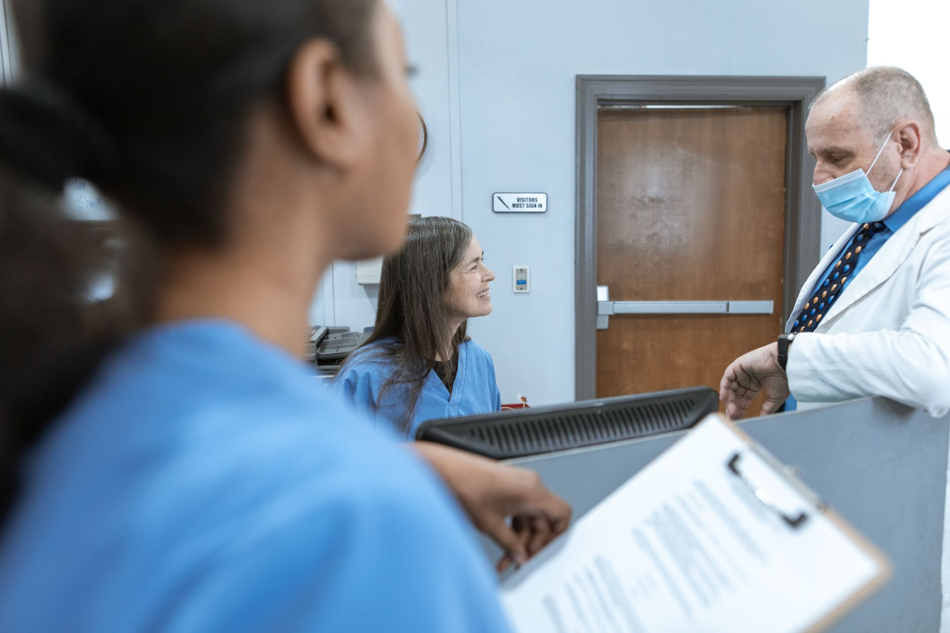 Medical professionals engage in discussion about scans at a healthcare facility.