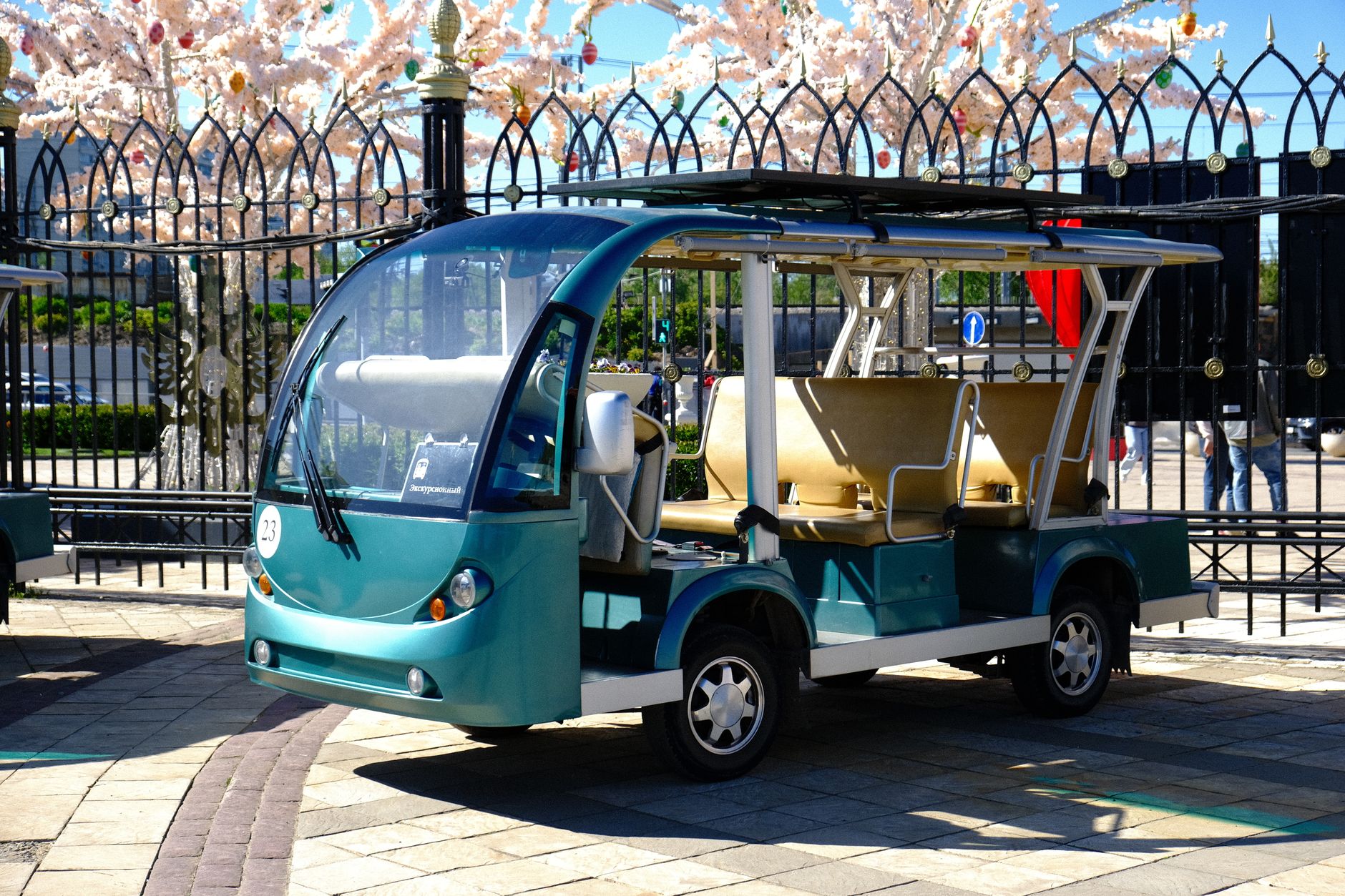 A green electric shuttle vehicle parked at Istanbul Airport, showcasing eco-friendly transport for international patients.