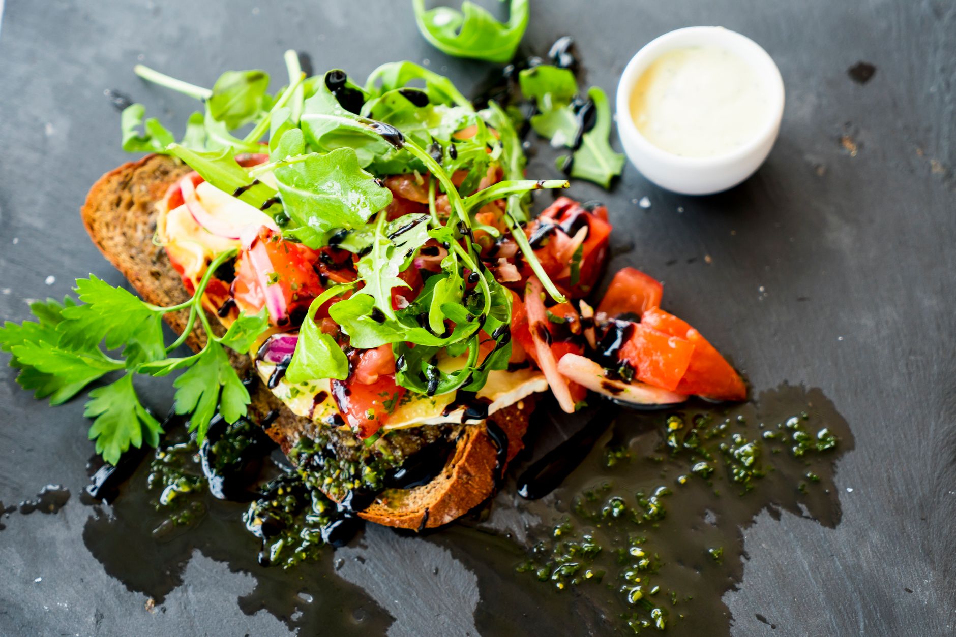 Mediterranean toast topped with fresh vegetables and dressing, served at a recovery resort.