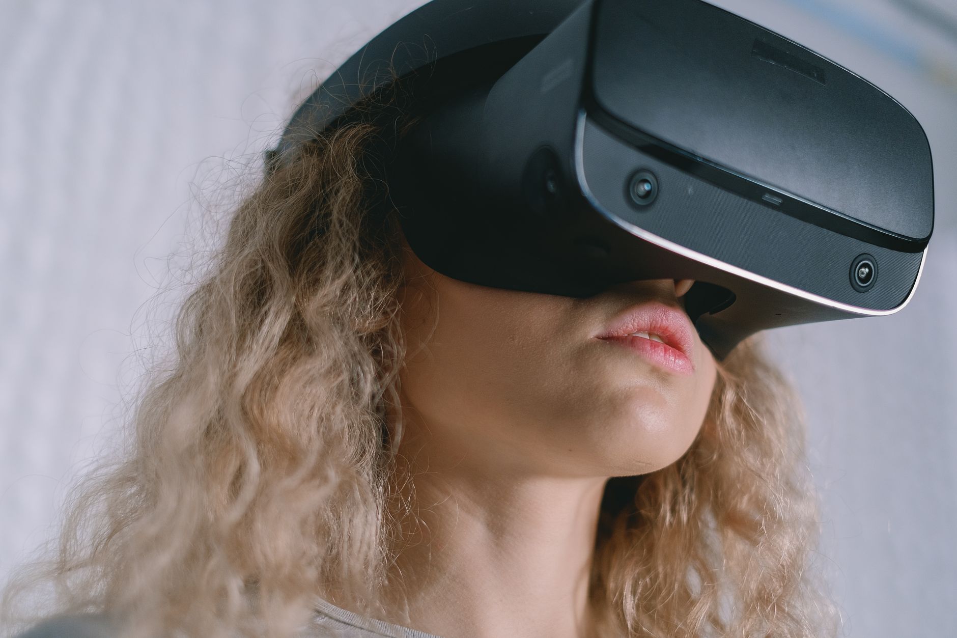 A close-up of a person wearing a VR headset, focused on advanced imaging technology.
