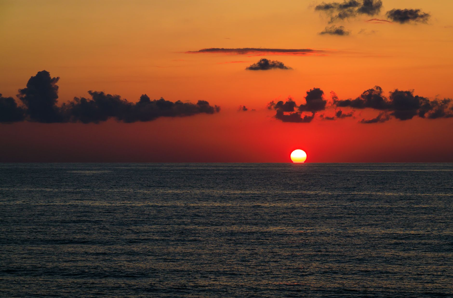 A serene sunset casts vibrant colors over the Black Sea, symbolizing tranquility in Trabzon.