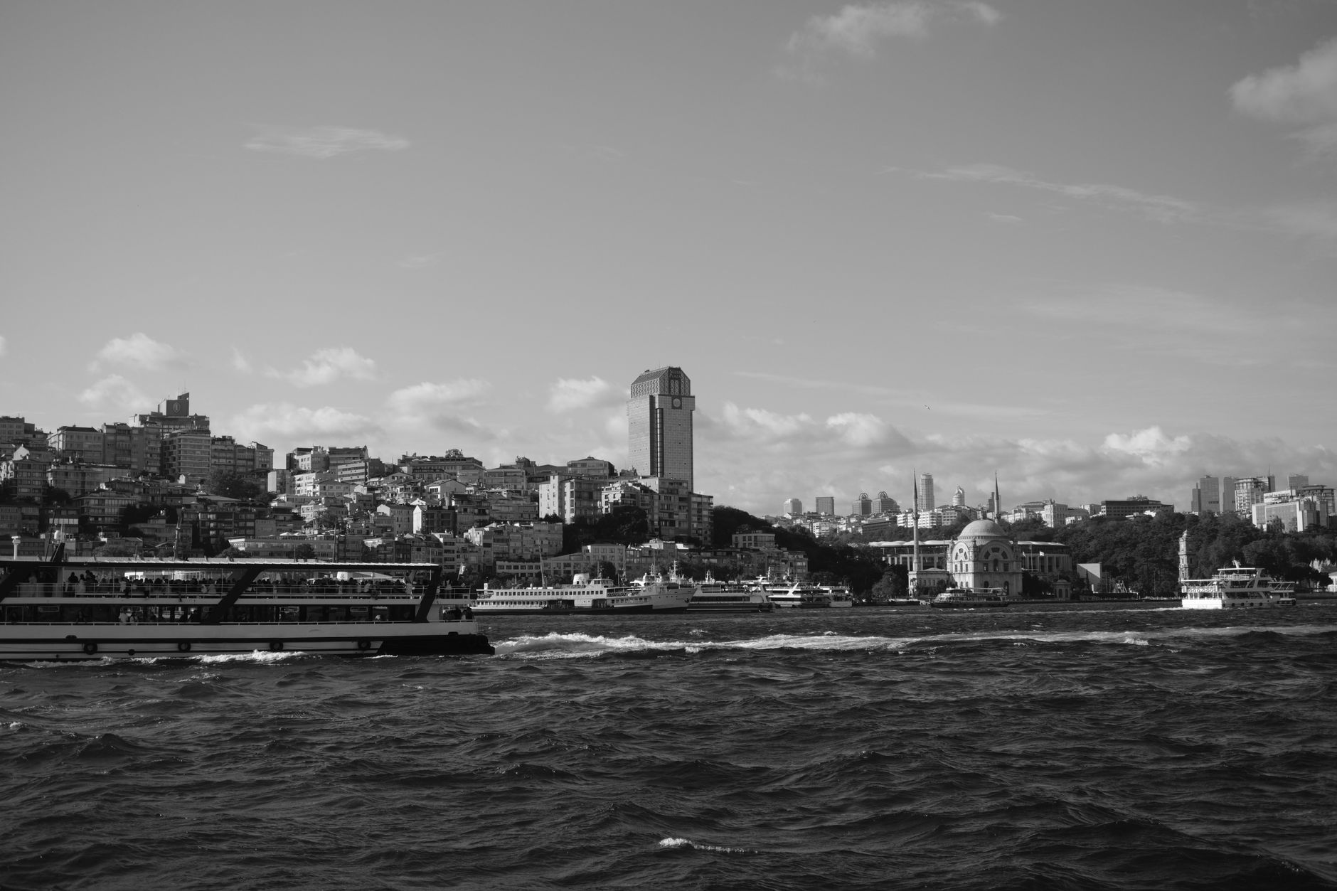 Scenic black and white view of Istanbul's skyline with boats, showcasing its appeal as a dental tourism destination.