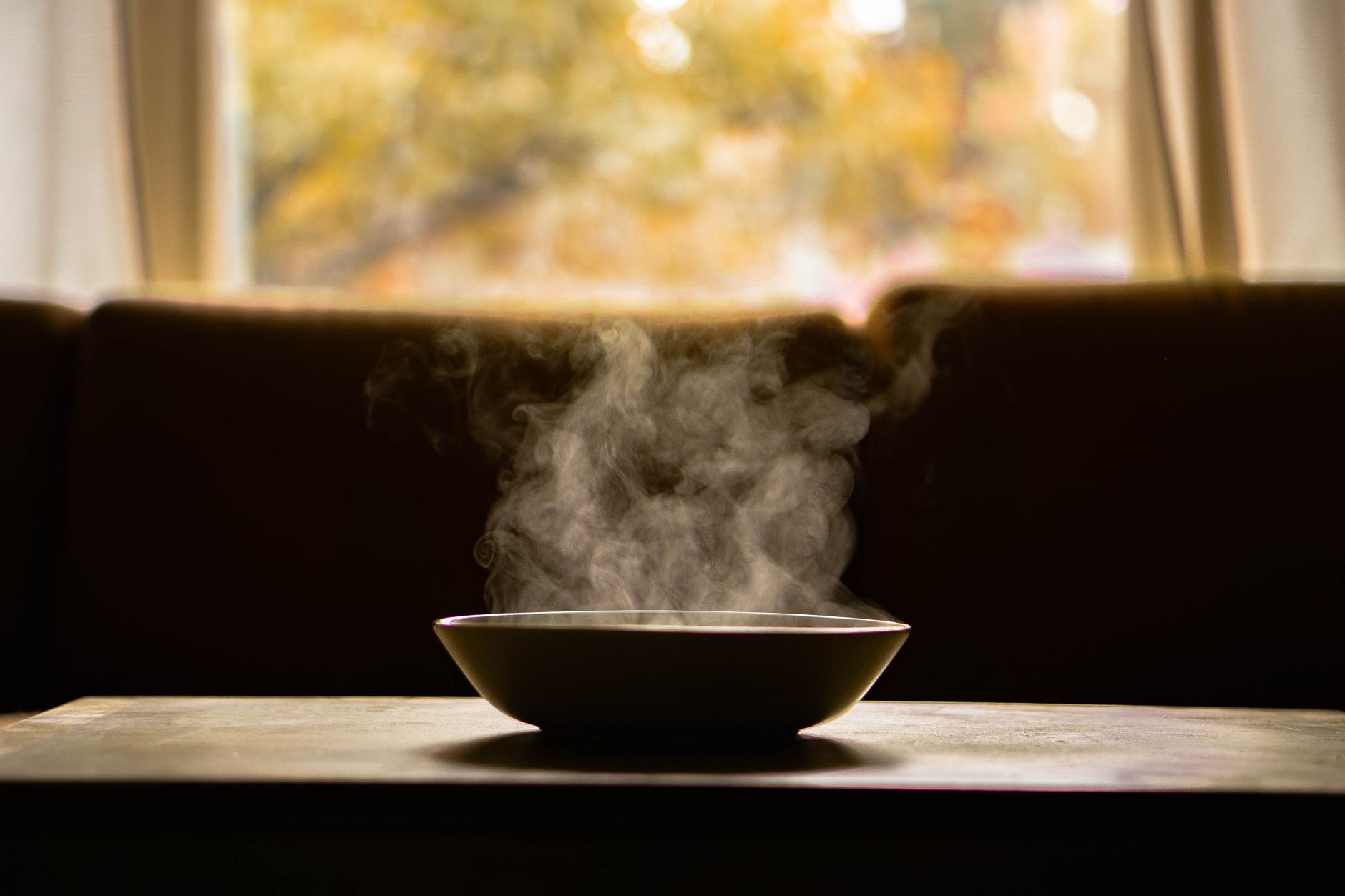 A steaming bowl on a wooden table, perfect for a post-operative recovery meal.