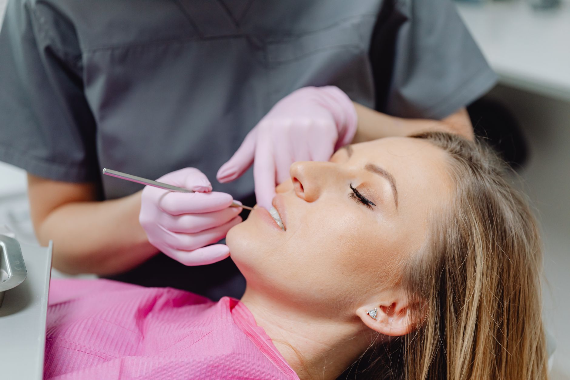 A dentist carefully fitting a crown on a patient's teeth in a Turkish clinic.