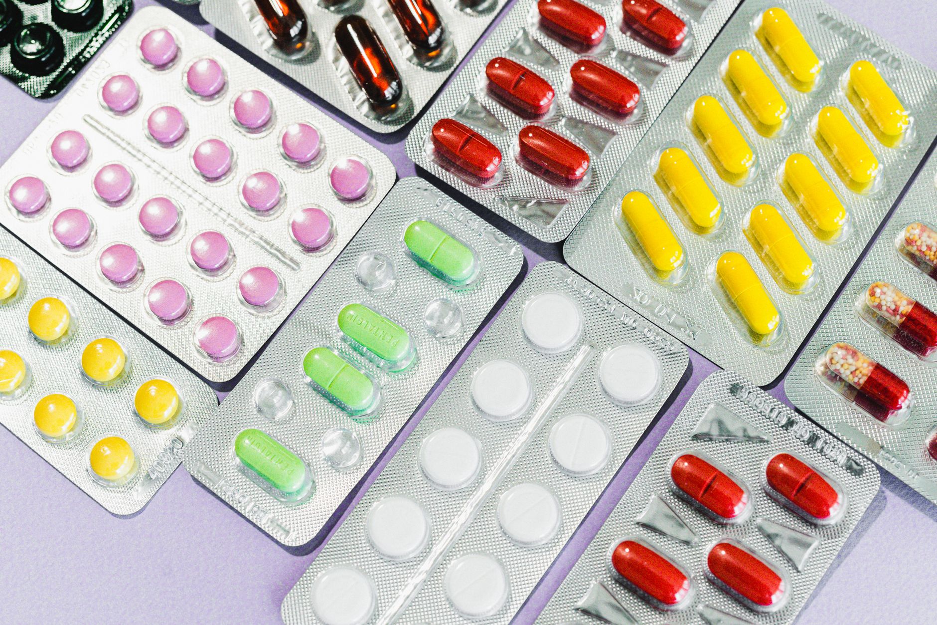 A variety of colorful medications in blisters, seen in a Turkish pharmacy setting.