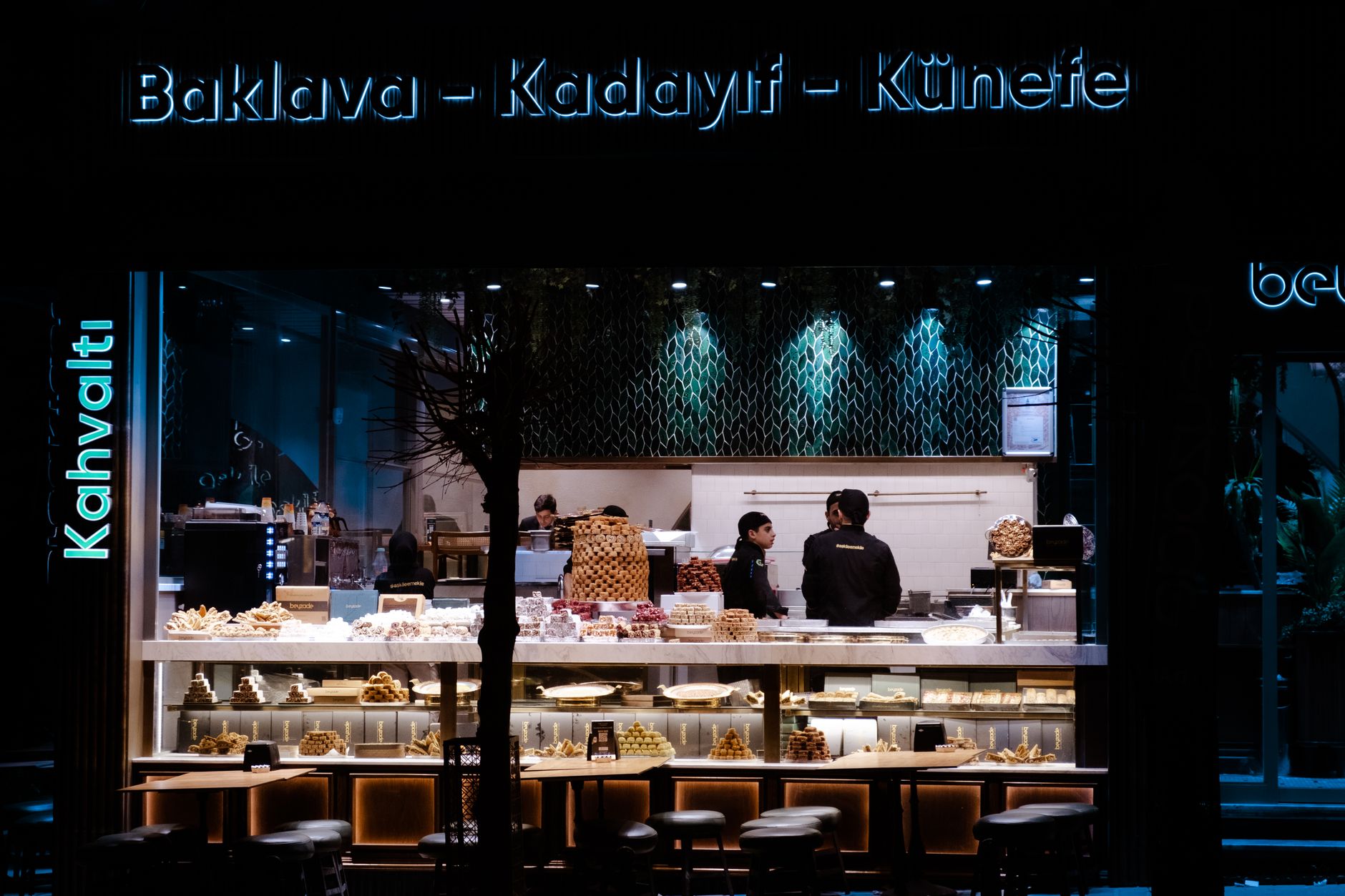 A dessert shop showcasing various Turkish sweets including baklava and kadayıf.