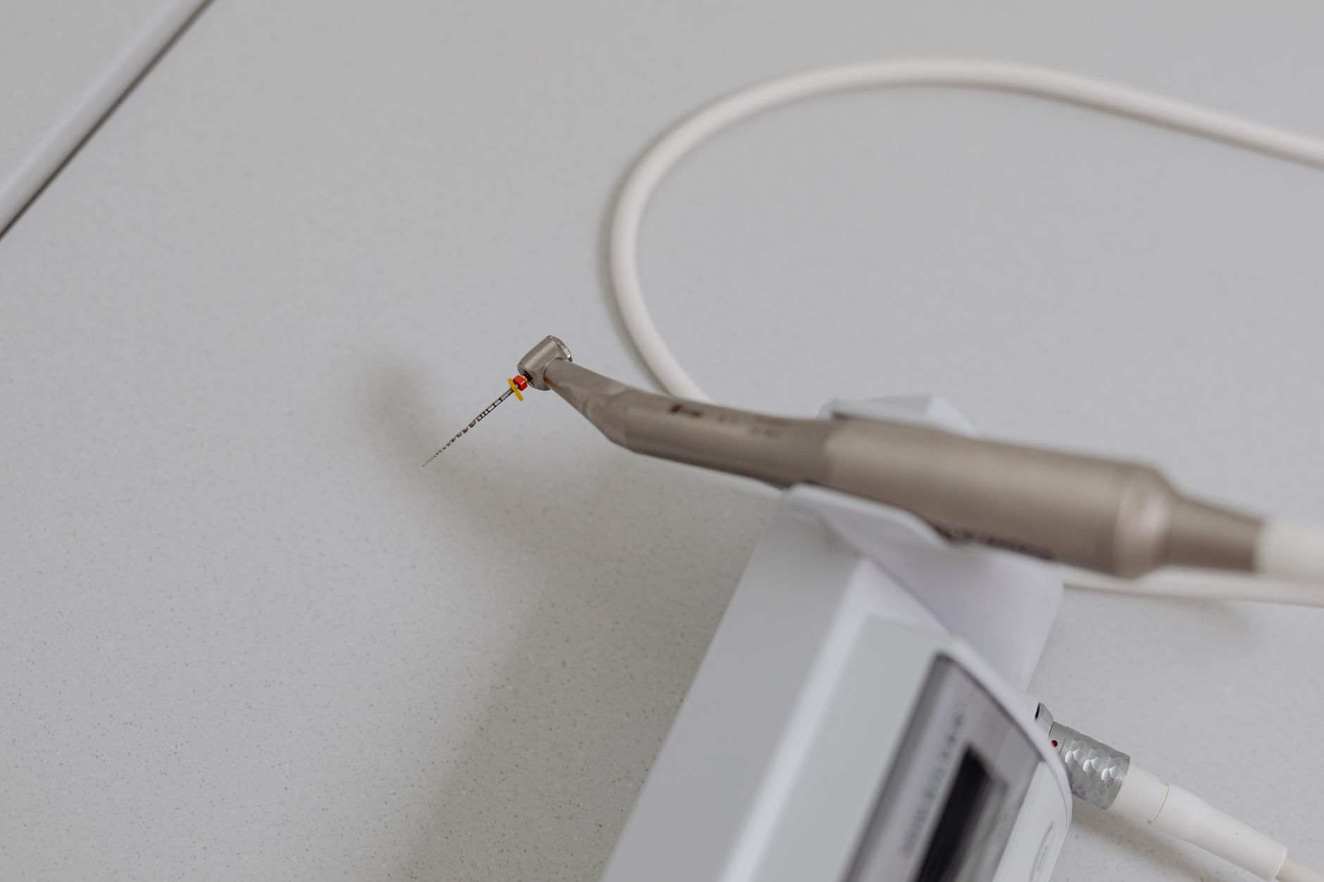 Precision dental tool with a small file for root canal treatment in a modern Turkish clinic.