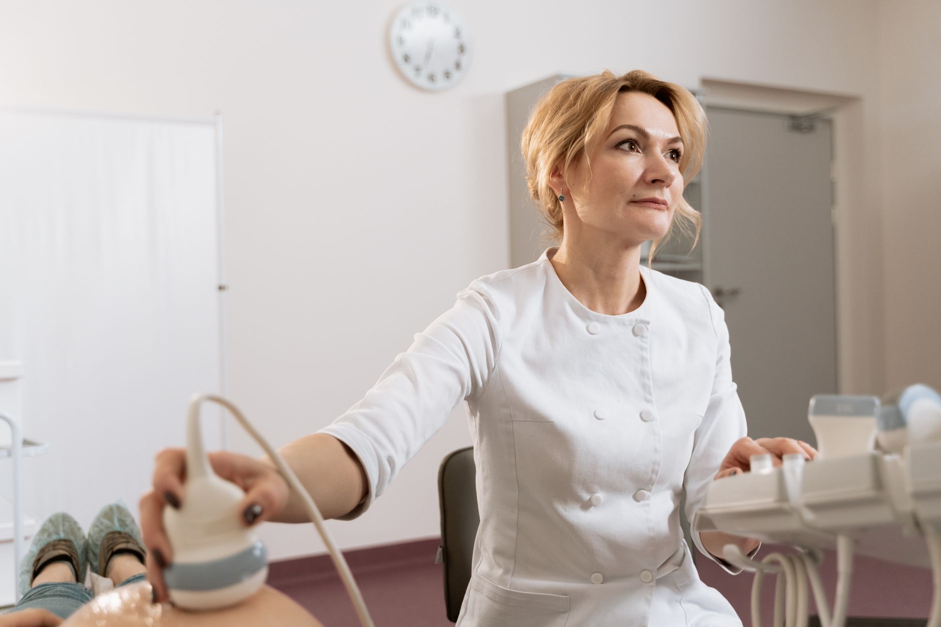 A healthcare professional conducts a transvaginal ultrasound consultation, emphasizing personalized care.