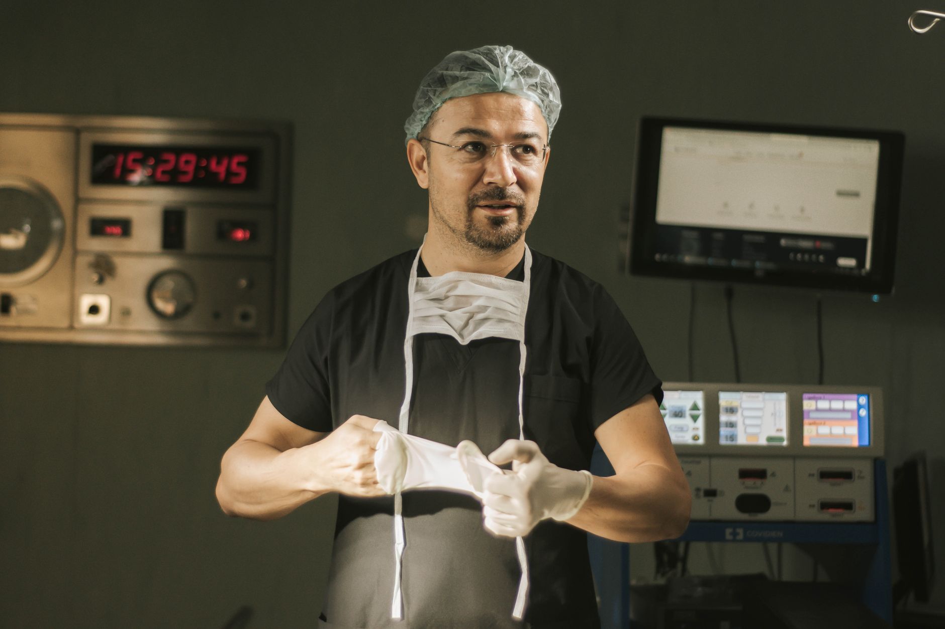 A neurosurgeon in a high-tech operating room, preparing for brain surgery.