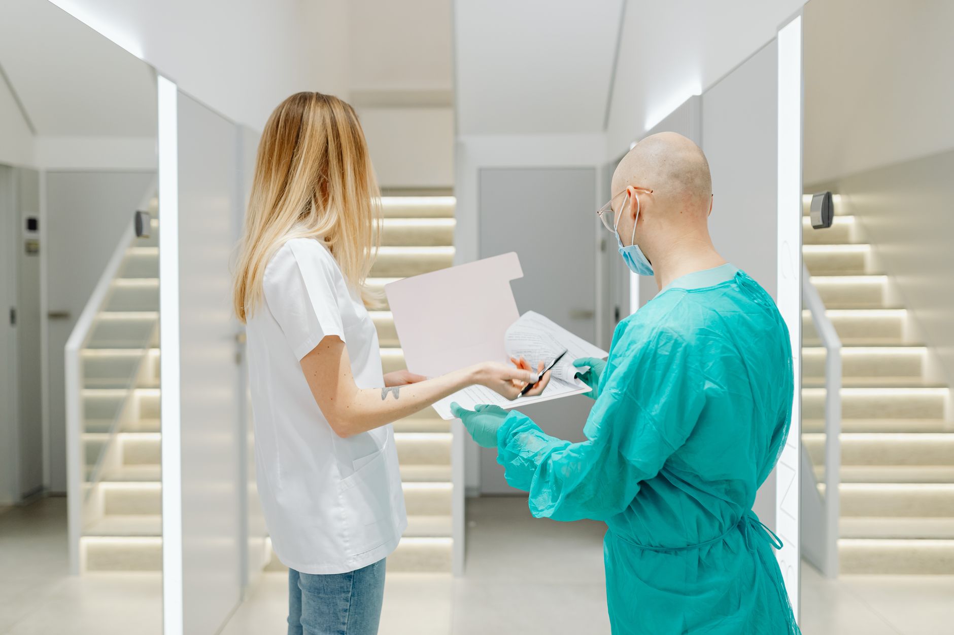 Doctor explaining hair transplant options to a patient in a clinic.