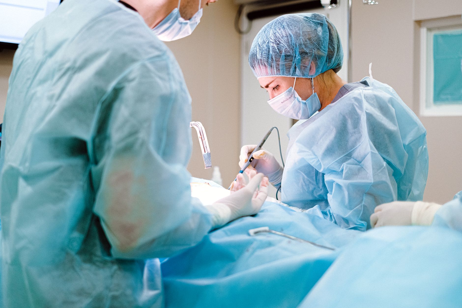 Surgeons performing LASIK eye surgery under a laser microscope.