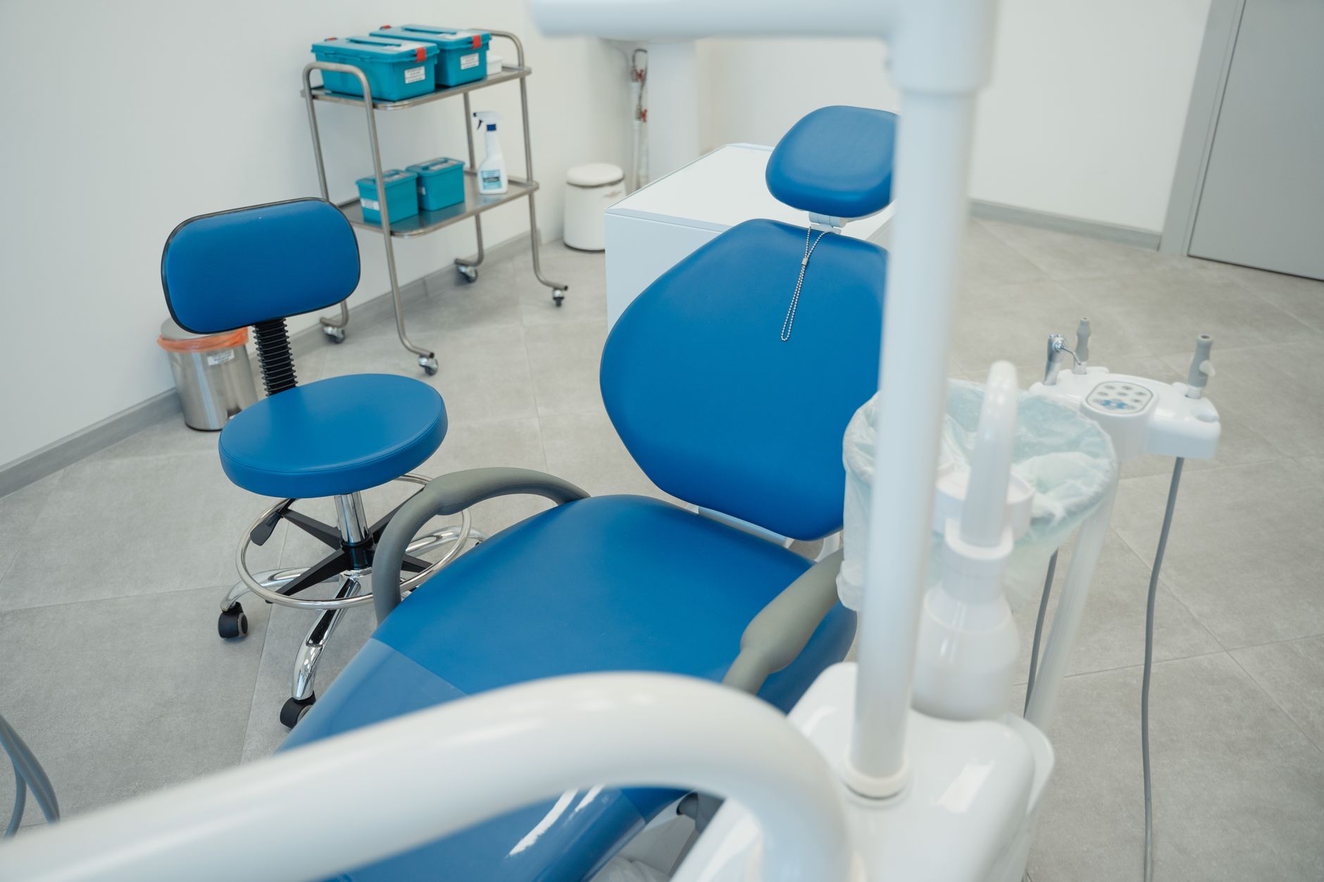 A clean dental clinic featuring modern blue chairs and advanced equipment in a bright setting.