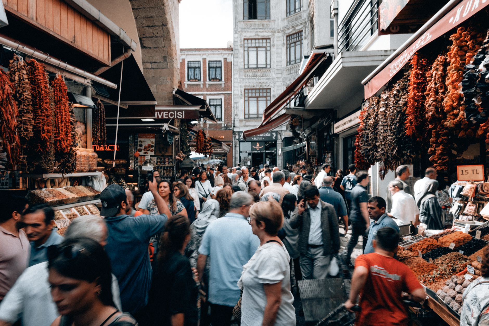 Travelers explore the bustling Grand Bazaar in Istanbul, filled with spices and local goods.