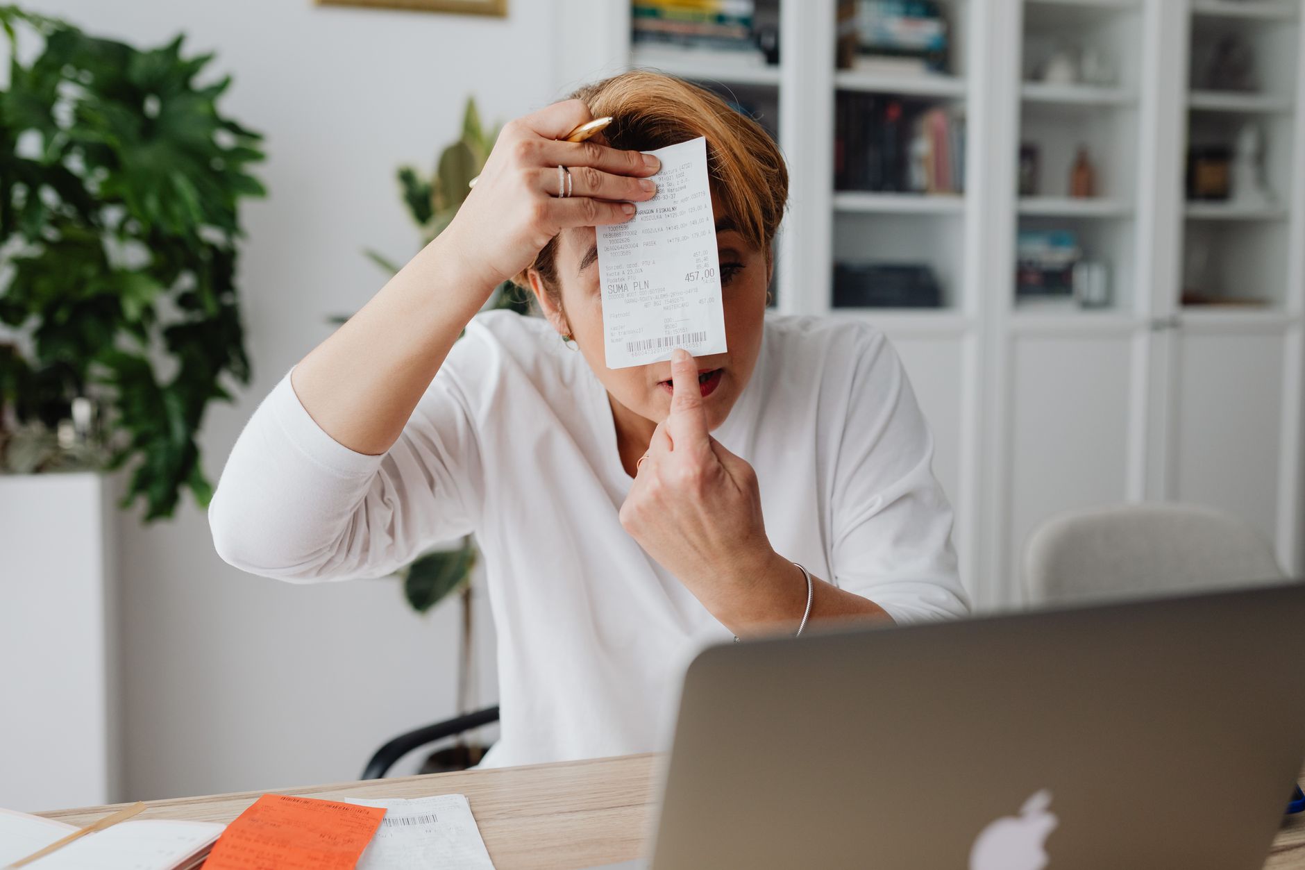 A woman displays a detailed hospital invoice, emphasizing transparent billing in a modern office setting.