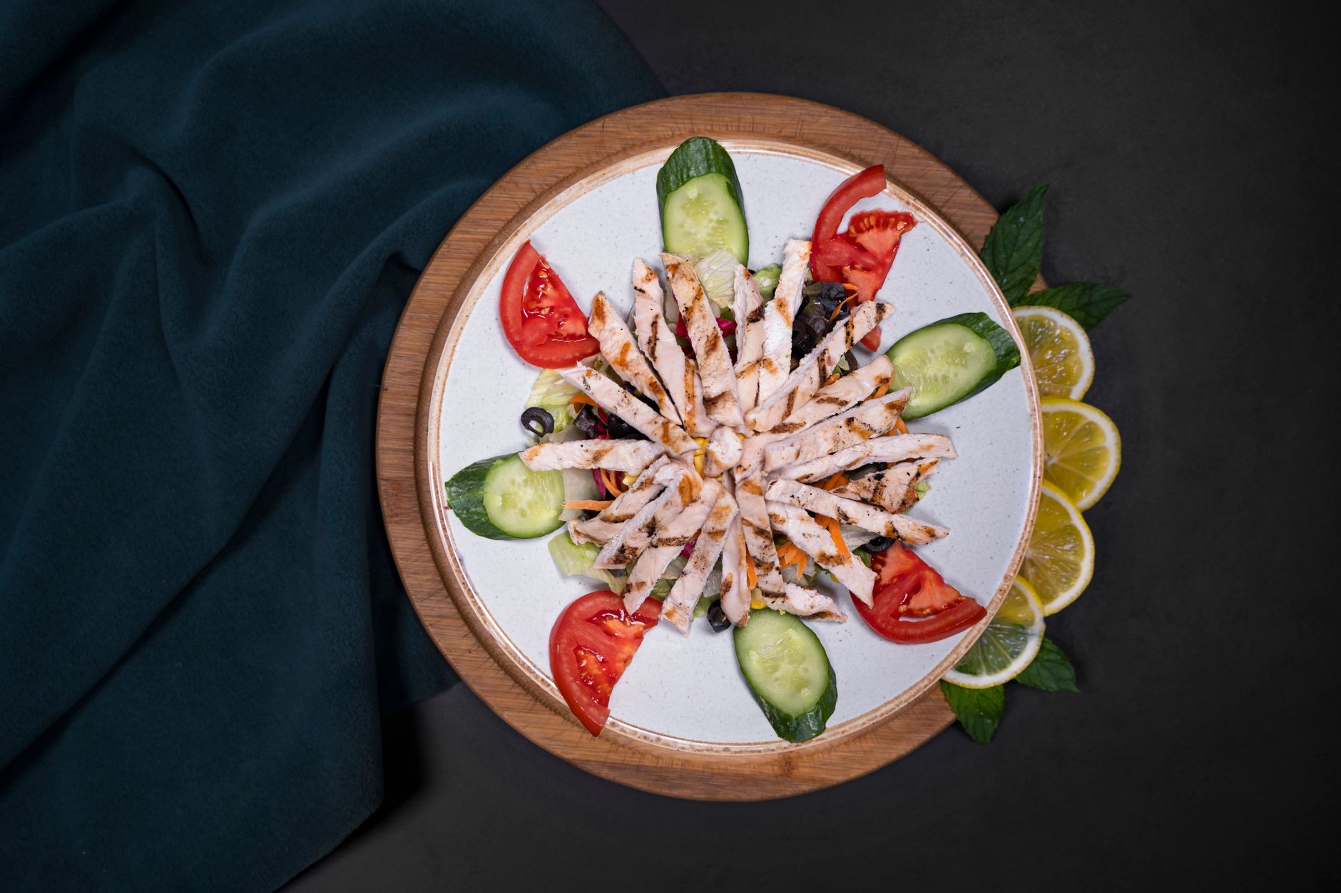 A colorful Mediterranean chicken salad with fresh vegetables and lean protein, ideal for a post-surgery meal.
