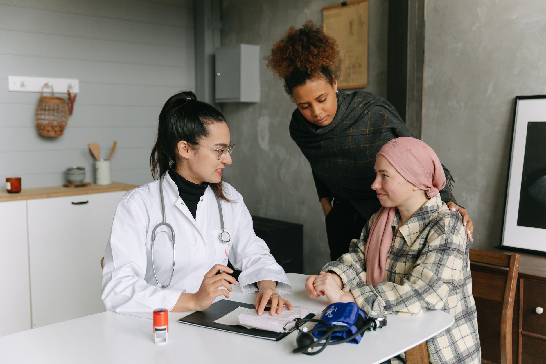 A clinician discusses patient rights with a patient and companion in a cozy office.