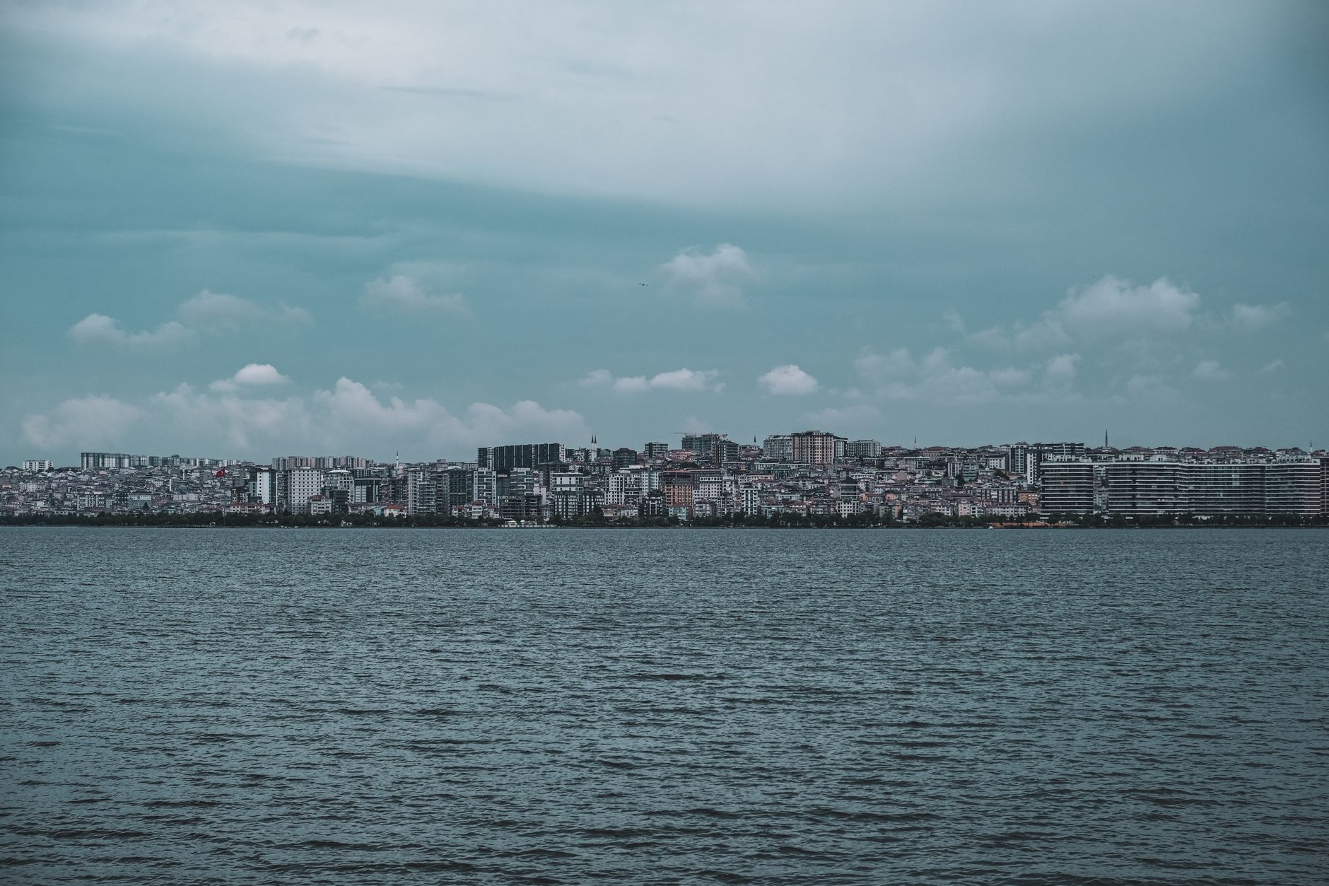Panoramic view of Istanbul's skyline across the Bosphorus, showcasing modern buildings and a hint of historical architecture.