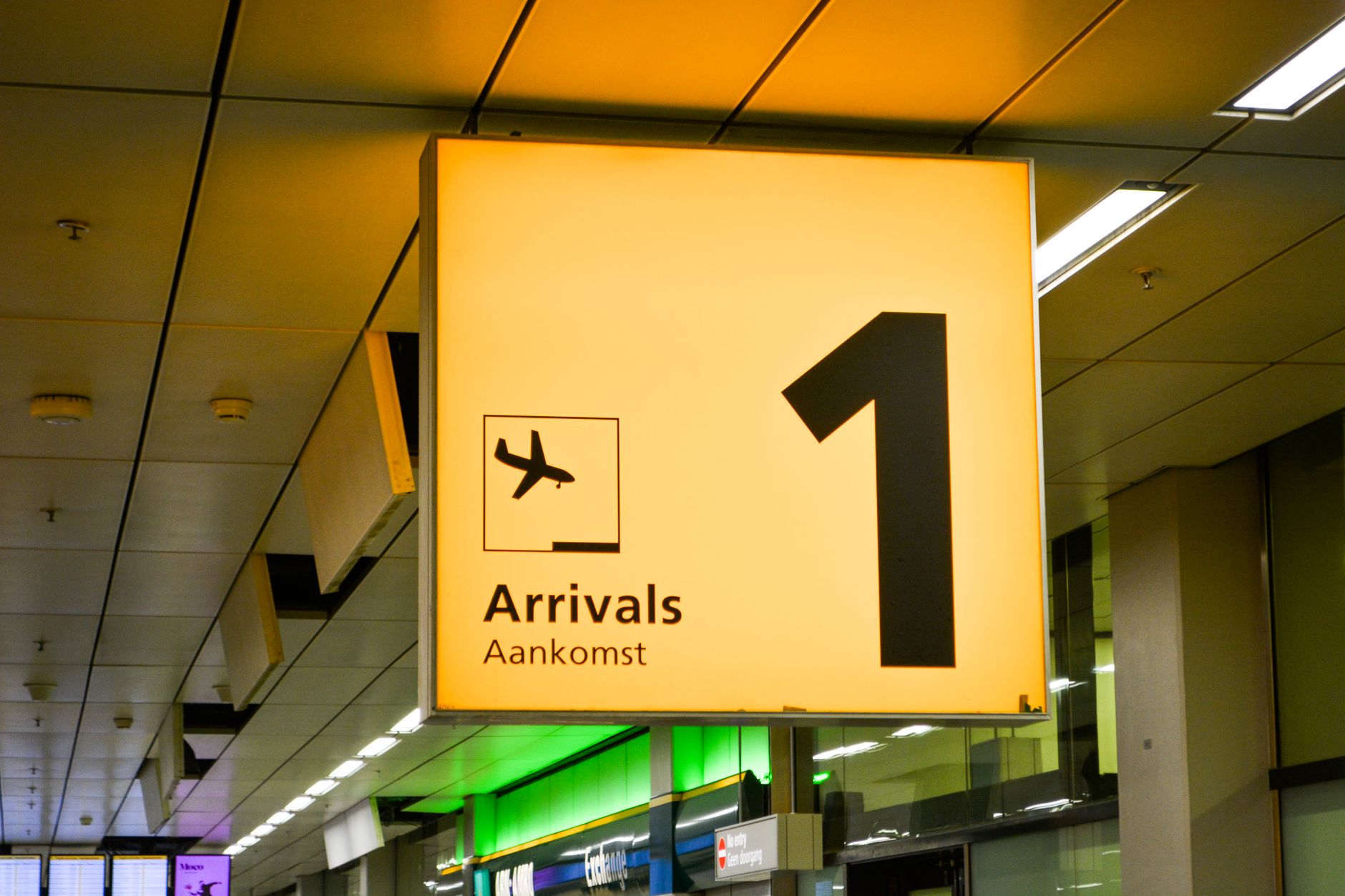 Sign indicating Arrivals area, with a plane icon and number 1 visible.