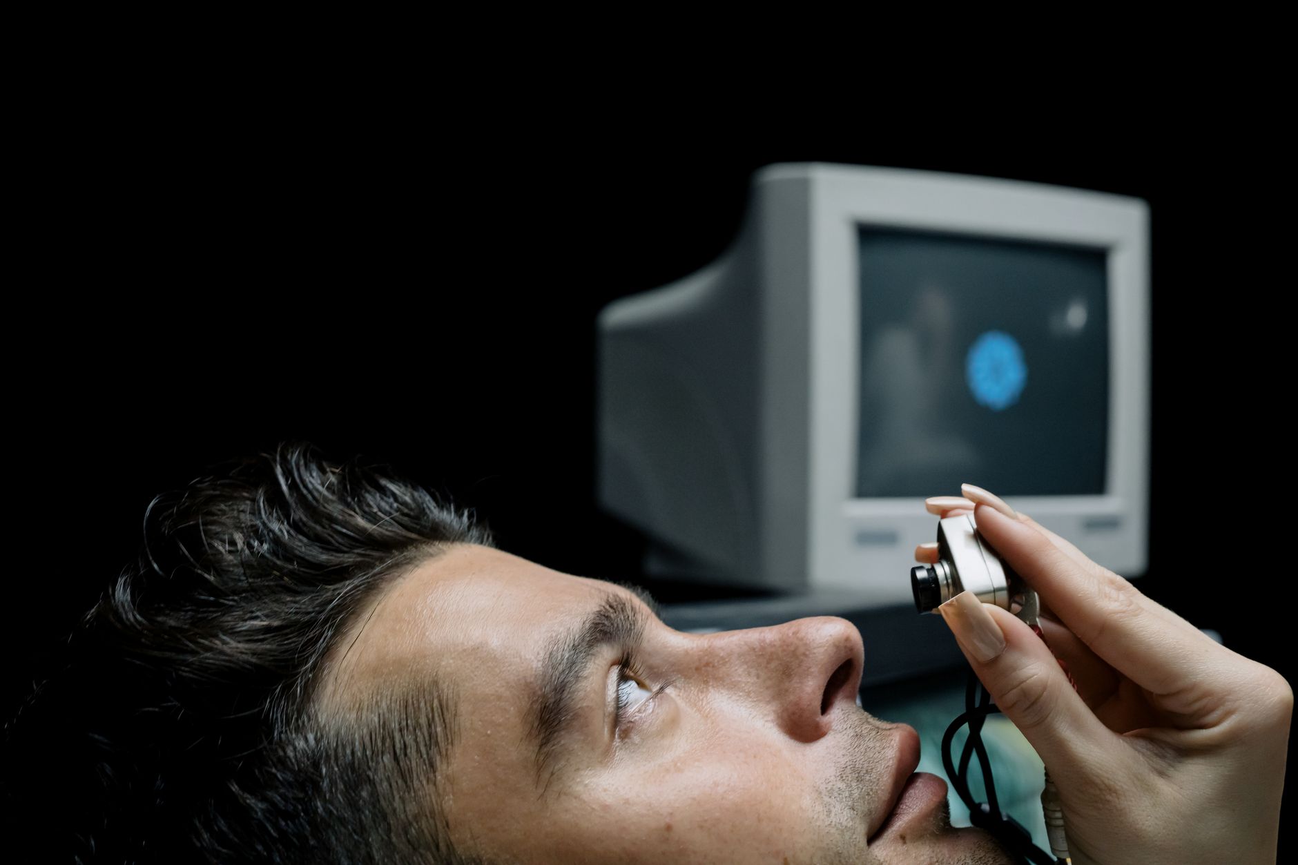 Close-up of a man undergoing an eye exam with modern technology.