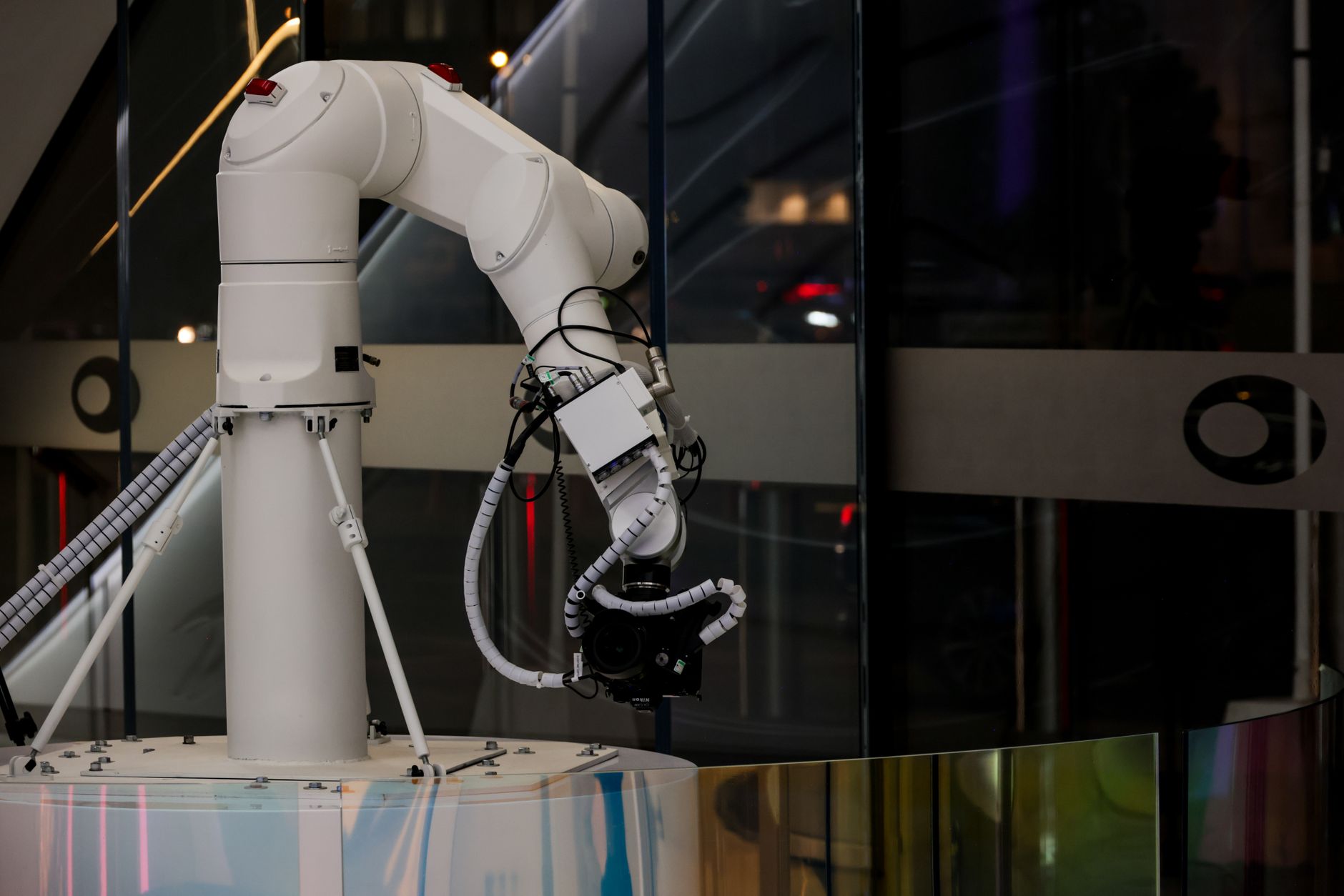 Close-up of a robotic arm equipped with surgical instruments in an operating room.