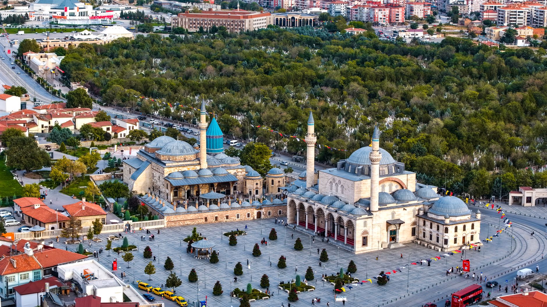 Aerial view showcasing the serene ambiance of Konya with historical mosques amidst lush greenery.