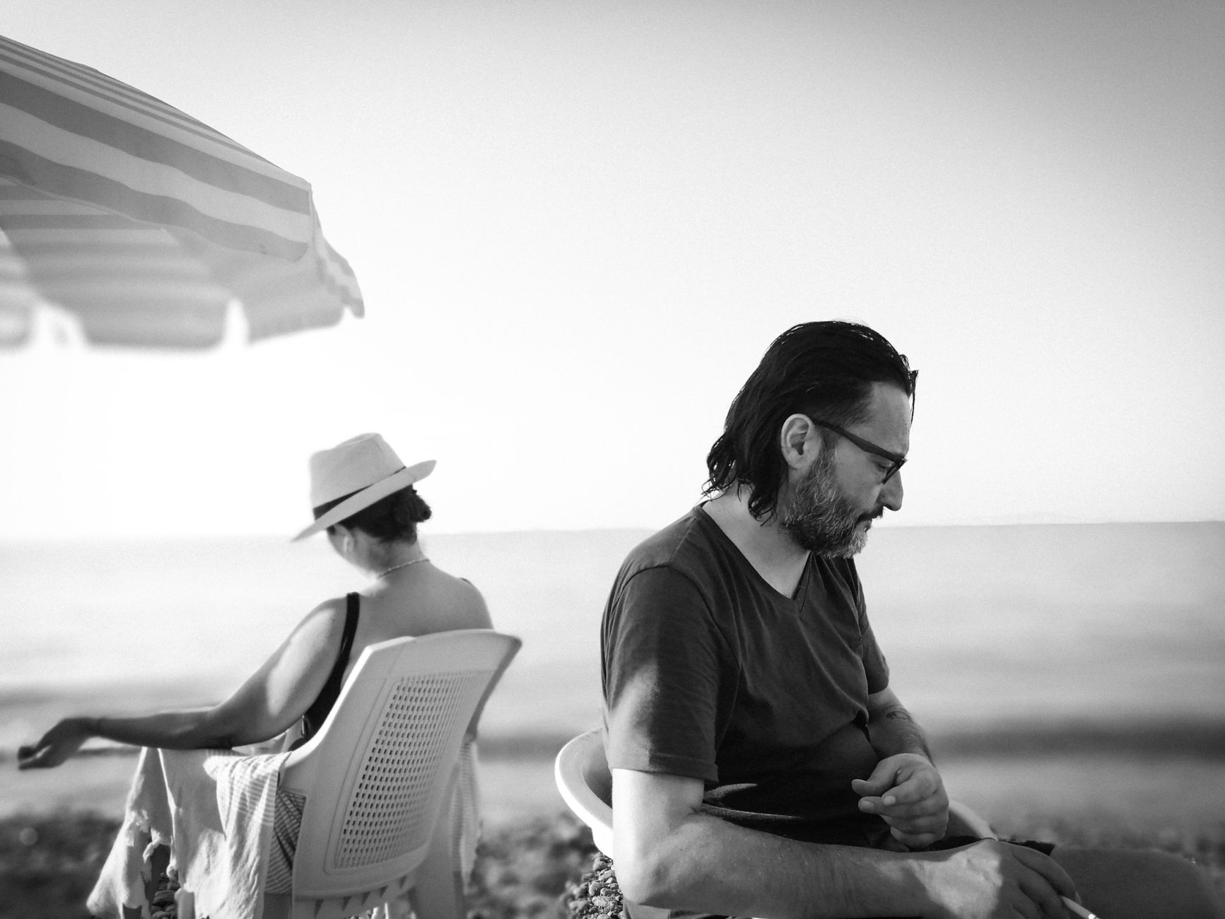 A couple sitting at the beach by the Black Sea, capturing a moment of emotional connection.