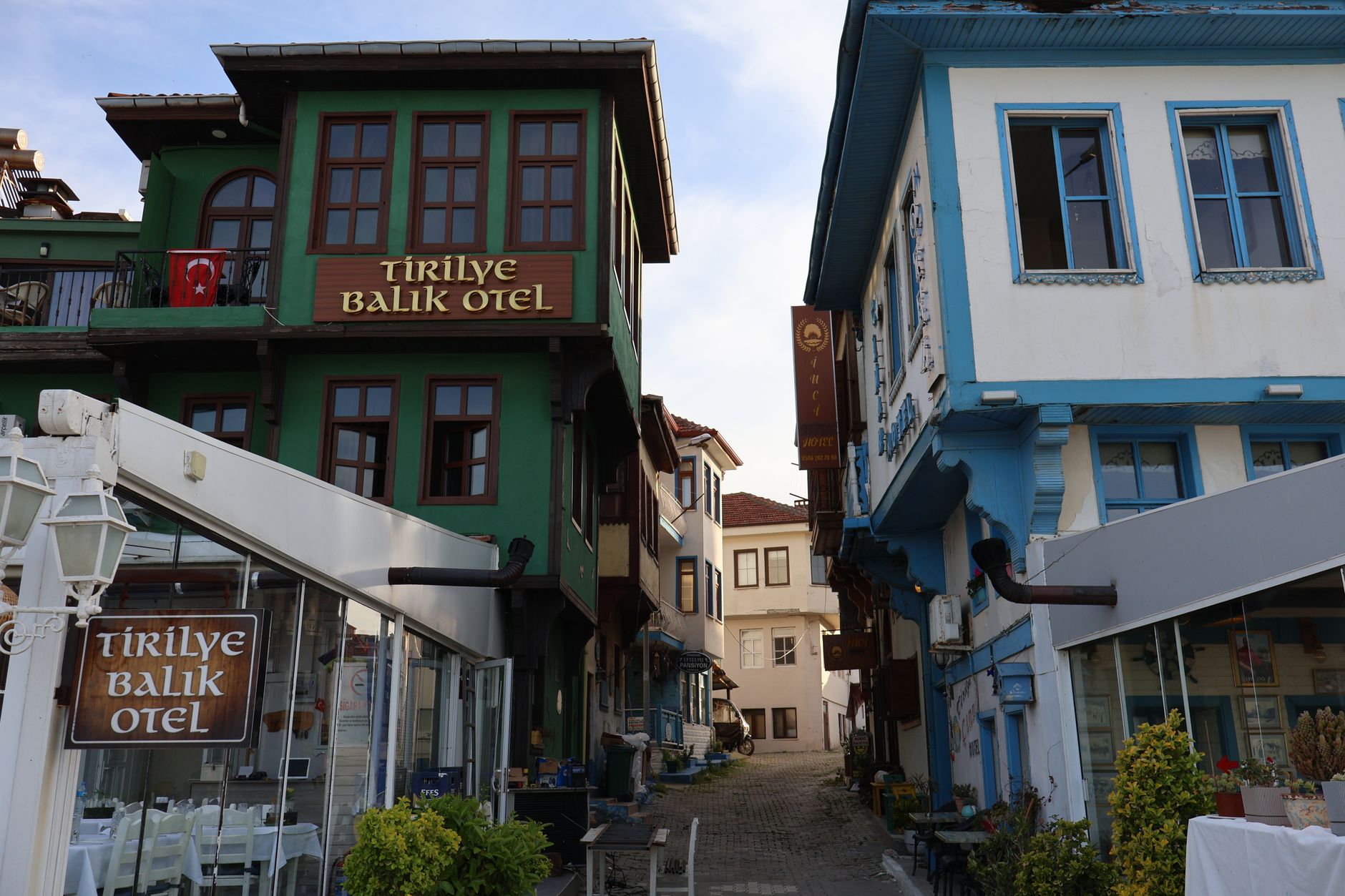 Picturesque view of Tirilye Balik Otel buildings in a calm Aegean town.