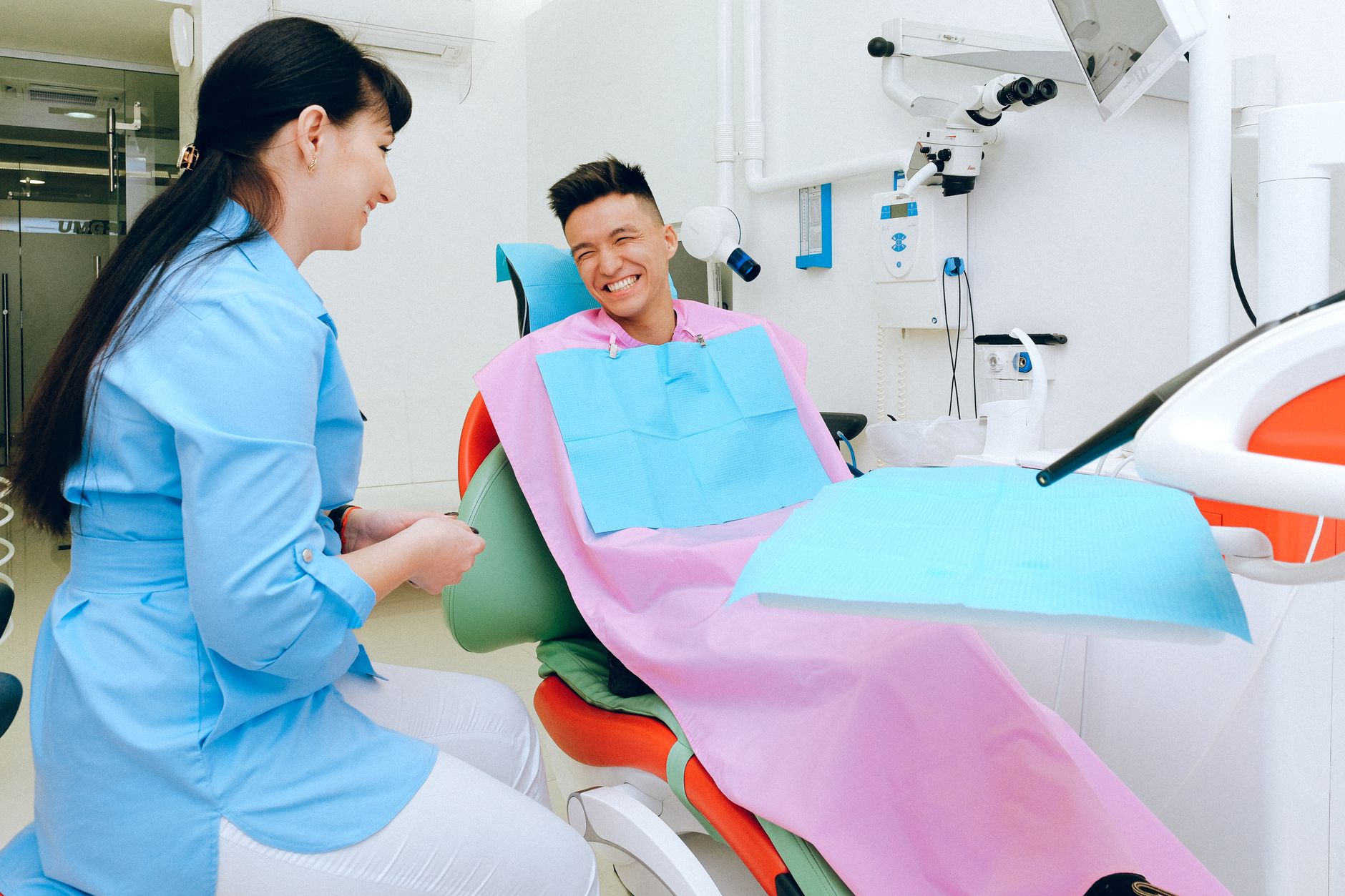 A dentist consulting with a patient in a modern dental office in Antalya.
