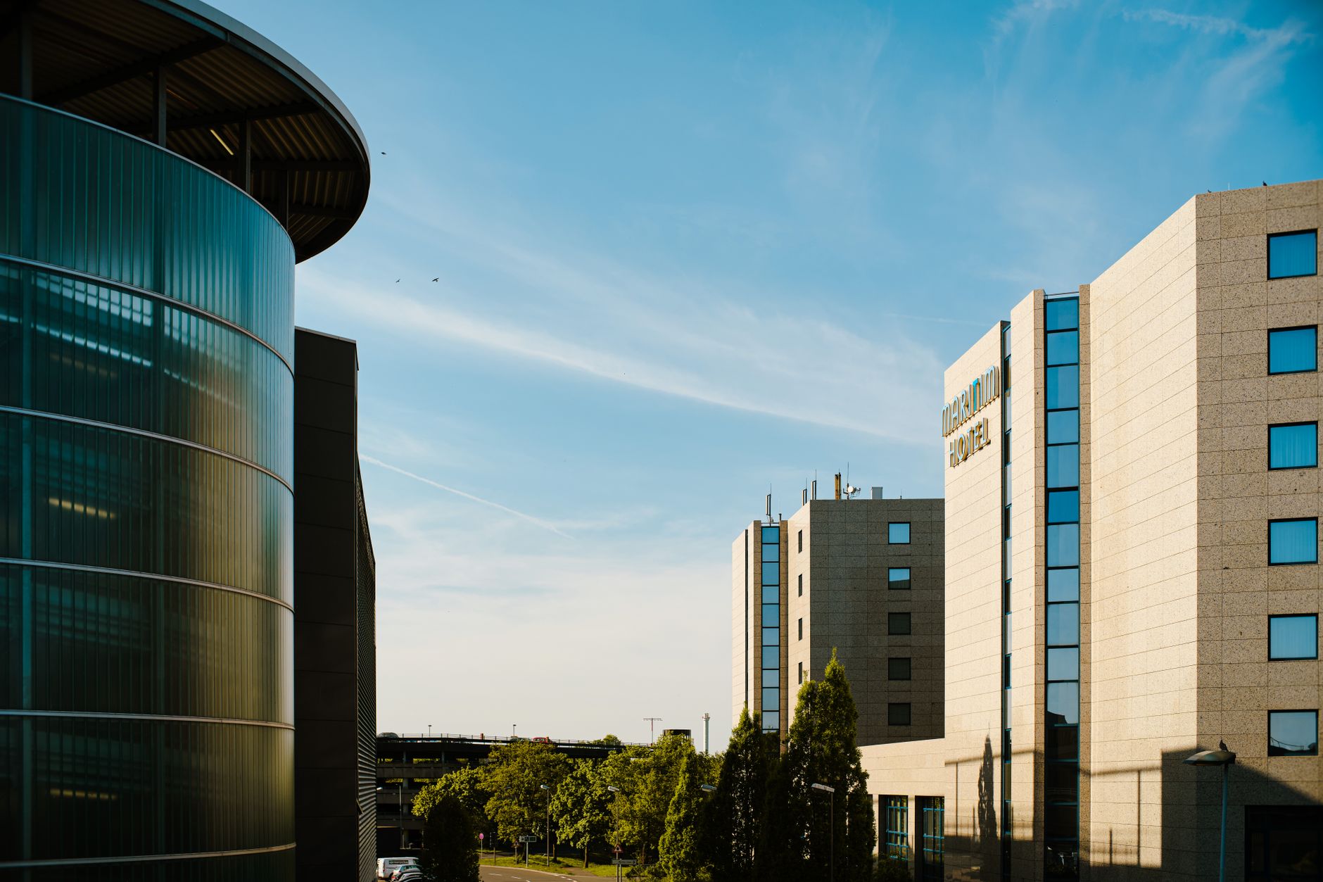 View of contemporary hospital buildings showcasing sleek design and greenery.