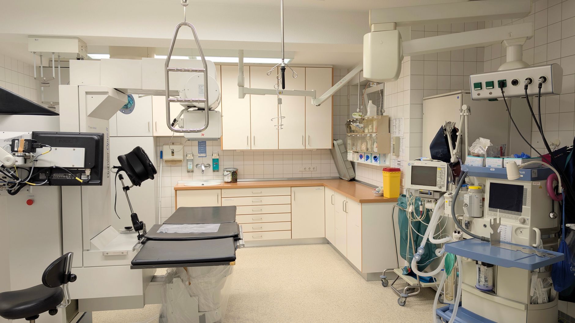 Inside a radiotherapy room featuring linear accelerator and medical equipment.