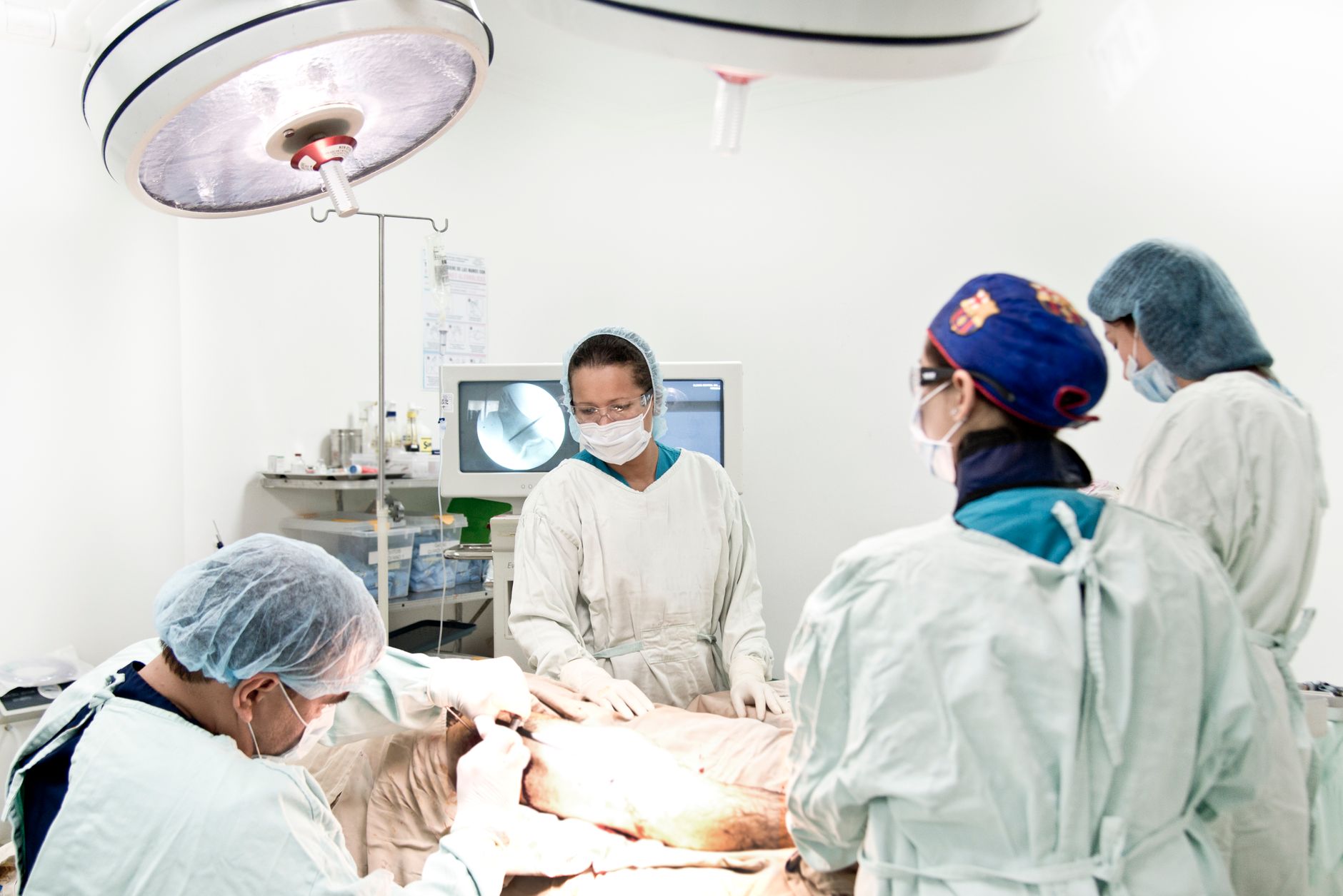 Surgeons perform a joint replacement surgery in a modern operating theatre.