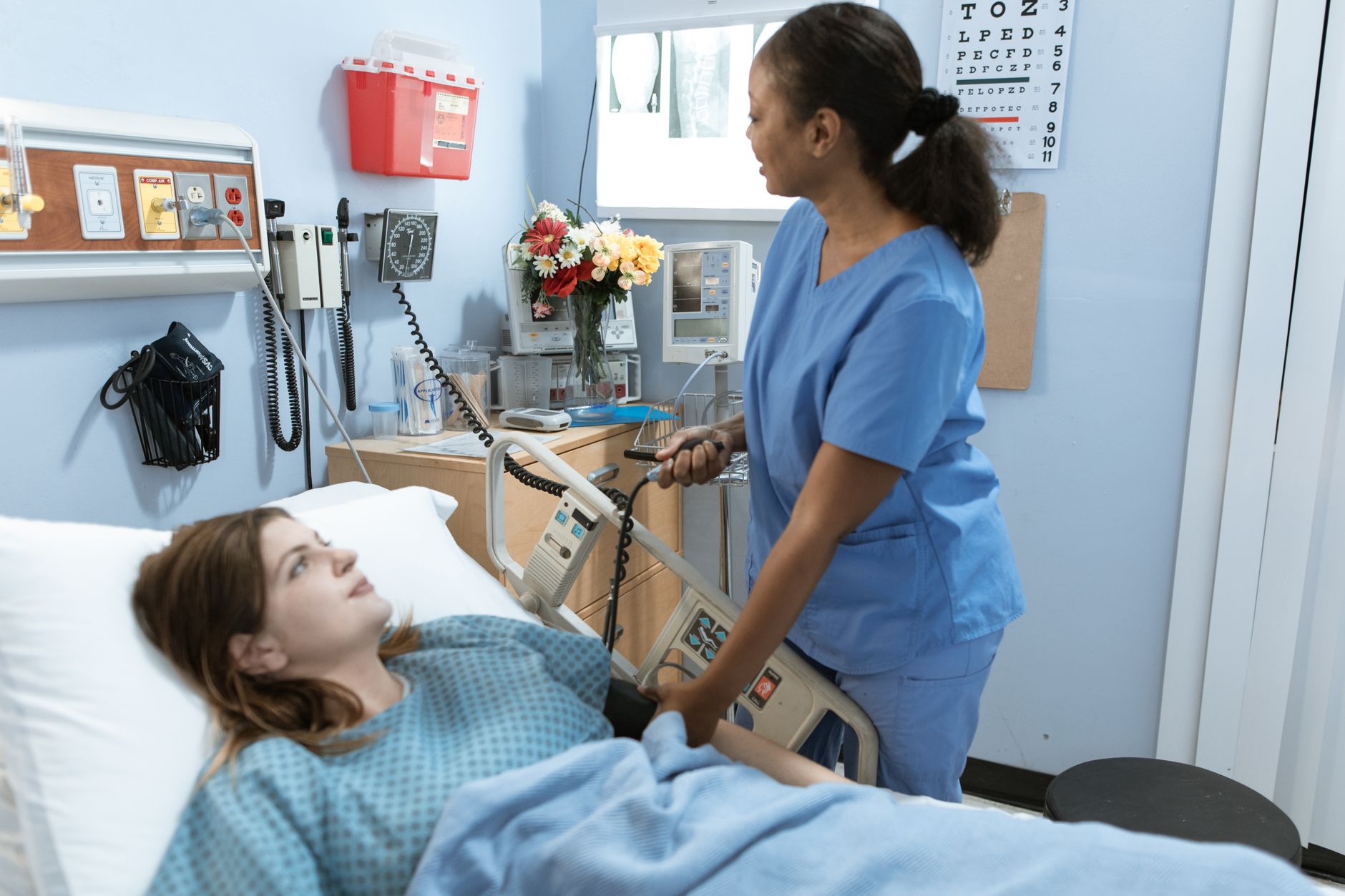 A nurse checks on a smiling patient in a cozy hospital room, creating a caring atmosphere.