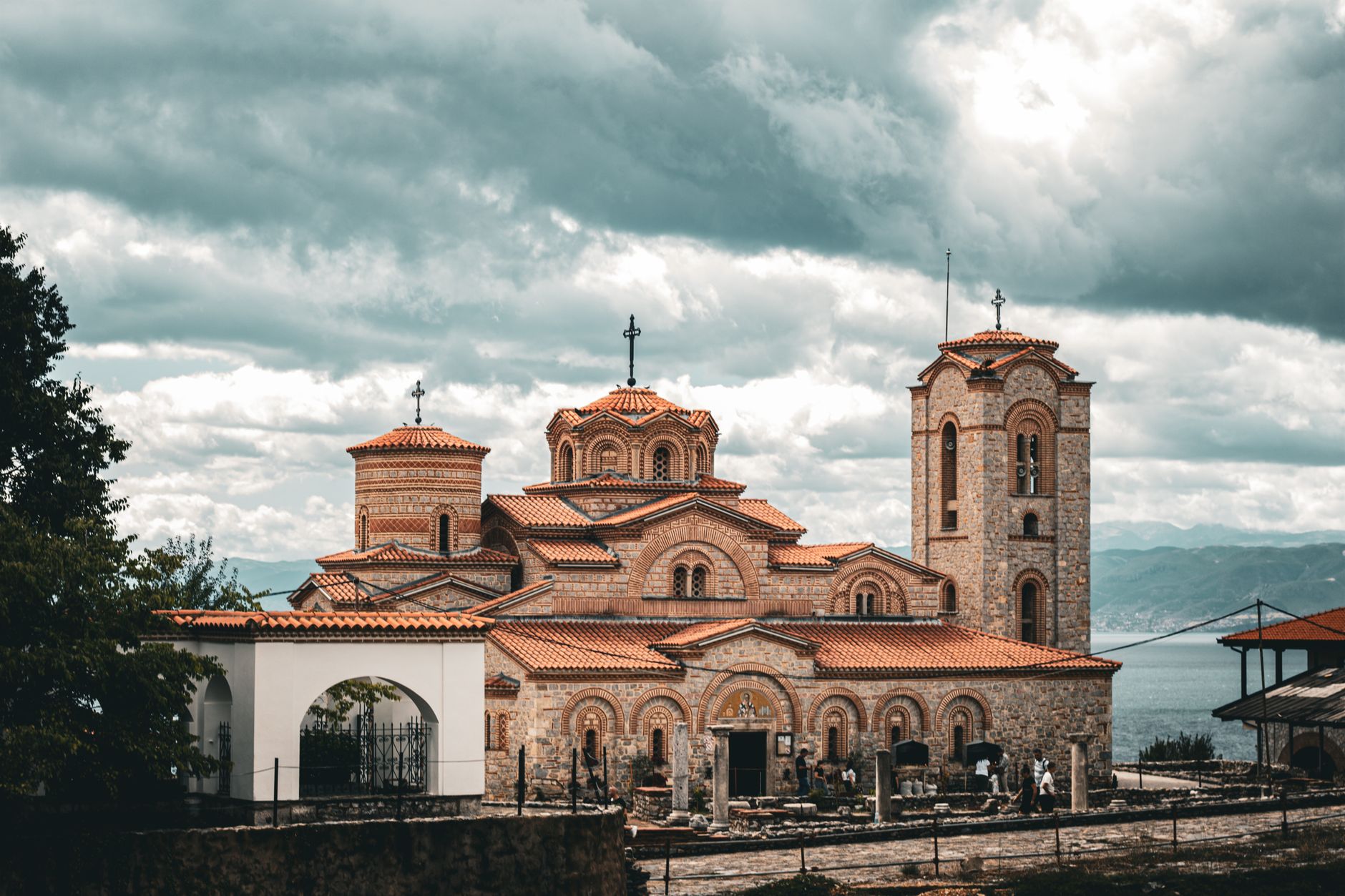 View of Byzantine monastery ruins on a small islet in Lake Bafa under cloudy skies.