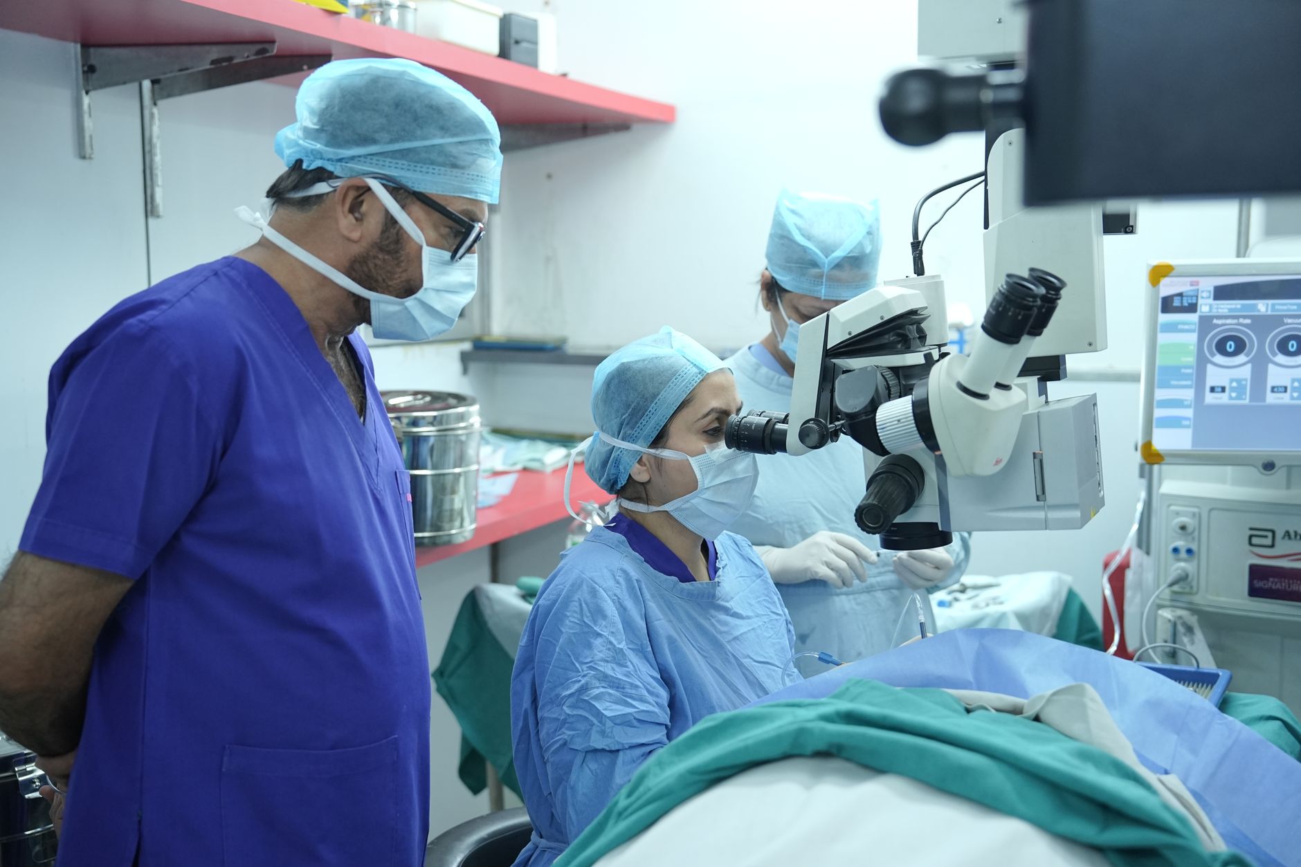Surgeons using advanced laser equipment for eye surgery in a clinic.