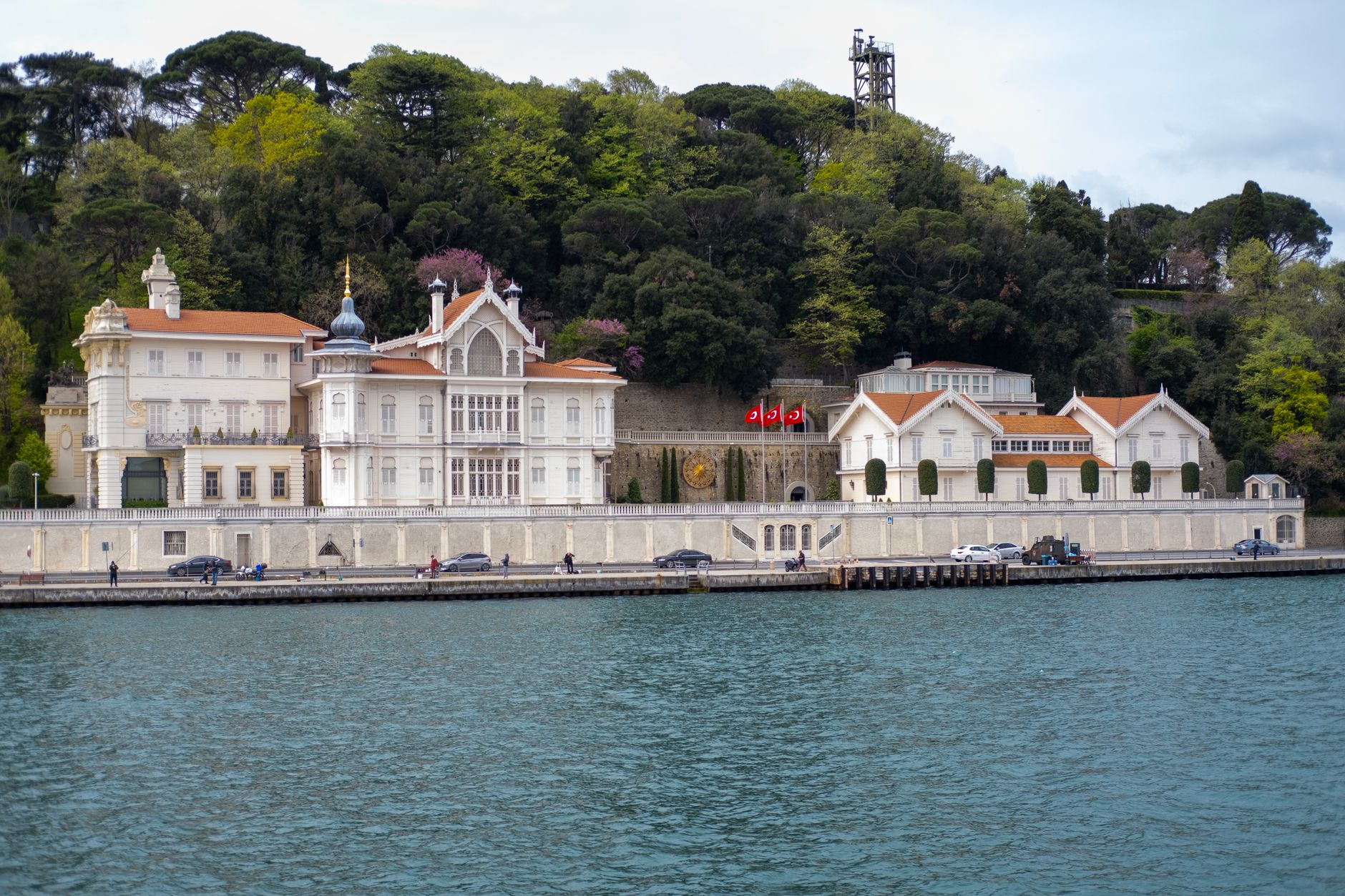 A picturesque waterfront scene in Istanbul featuring elegant buildings and lush greenery along the Bosphorus.