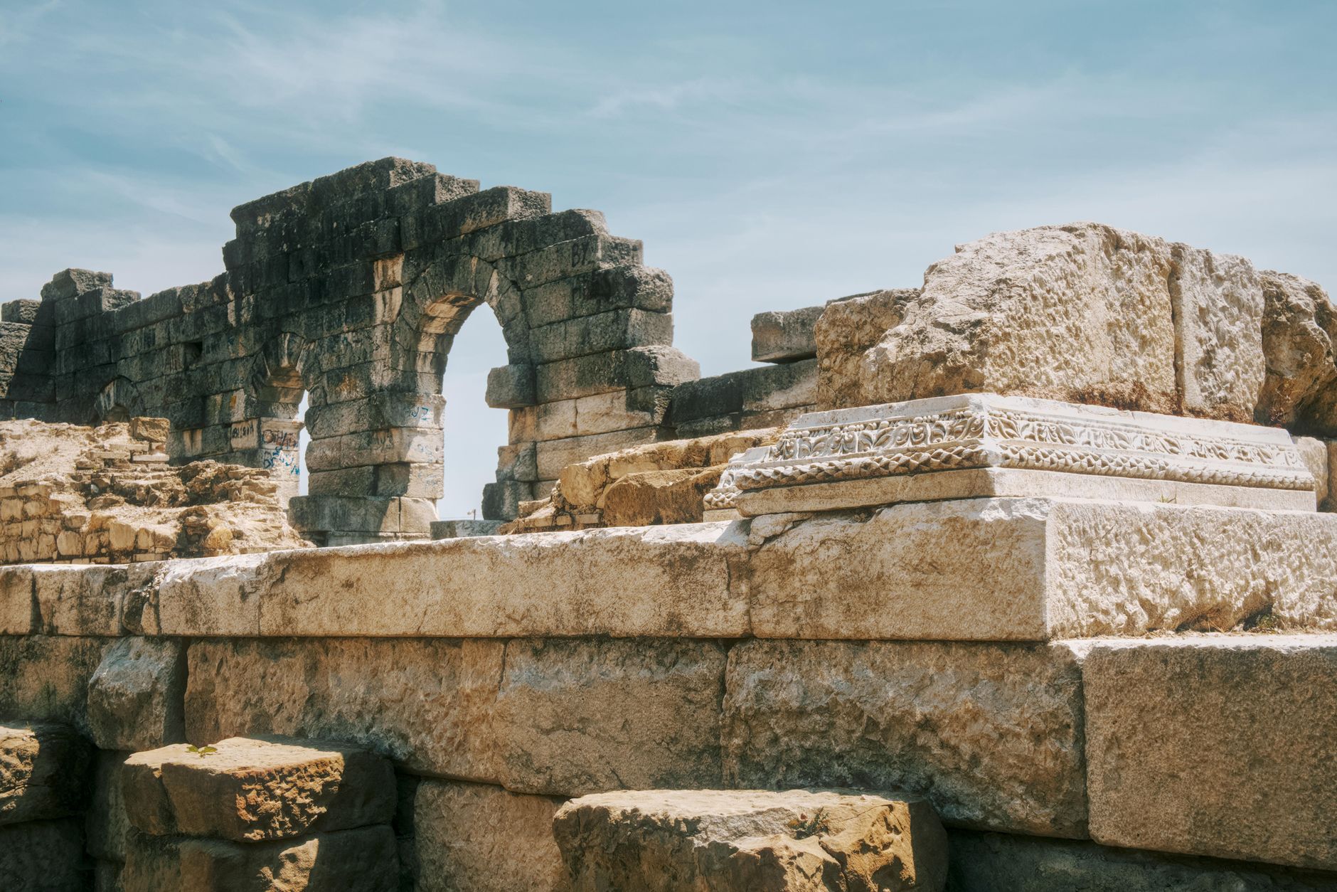 Remnants of Heraclea ad Latmum ruins, showcasing ancient stone architecture with a blue sky backdrop.