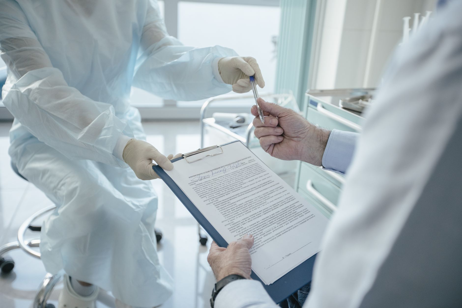 Close-up of a healthcare worker presenting medical insurance paperwork to a patient in Türkiye.